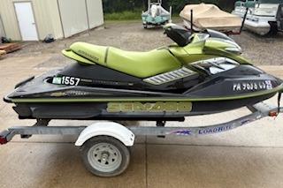 2004 Seadoo Bombardier jet ski on trailer, green and black design.