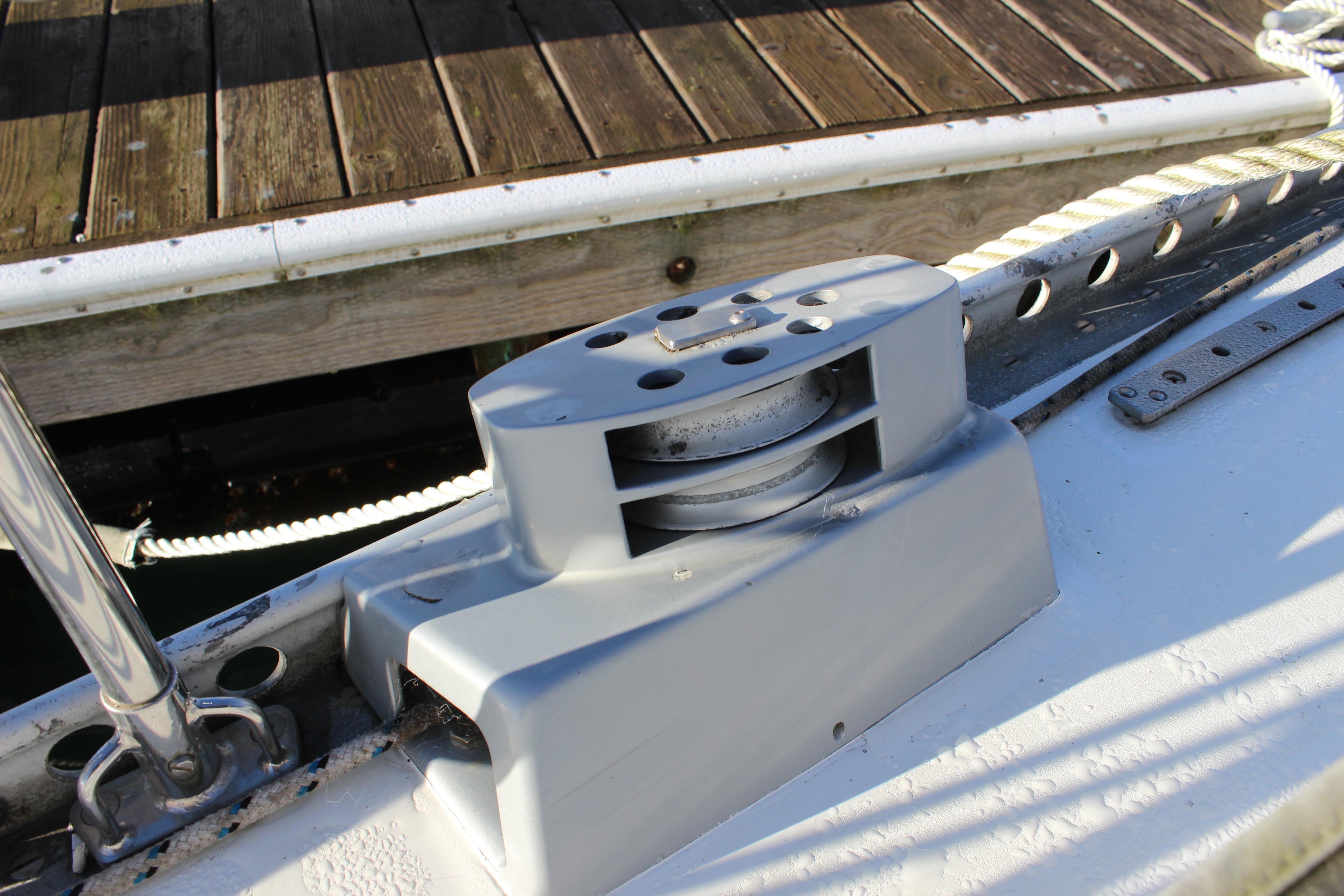 Deck detail of a 1973 Nautor Swan 44 sailboat, featuring a winch and cleat.