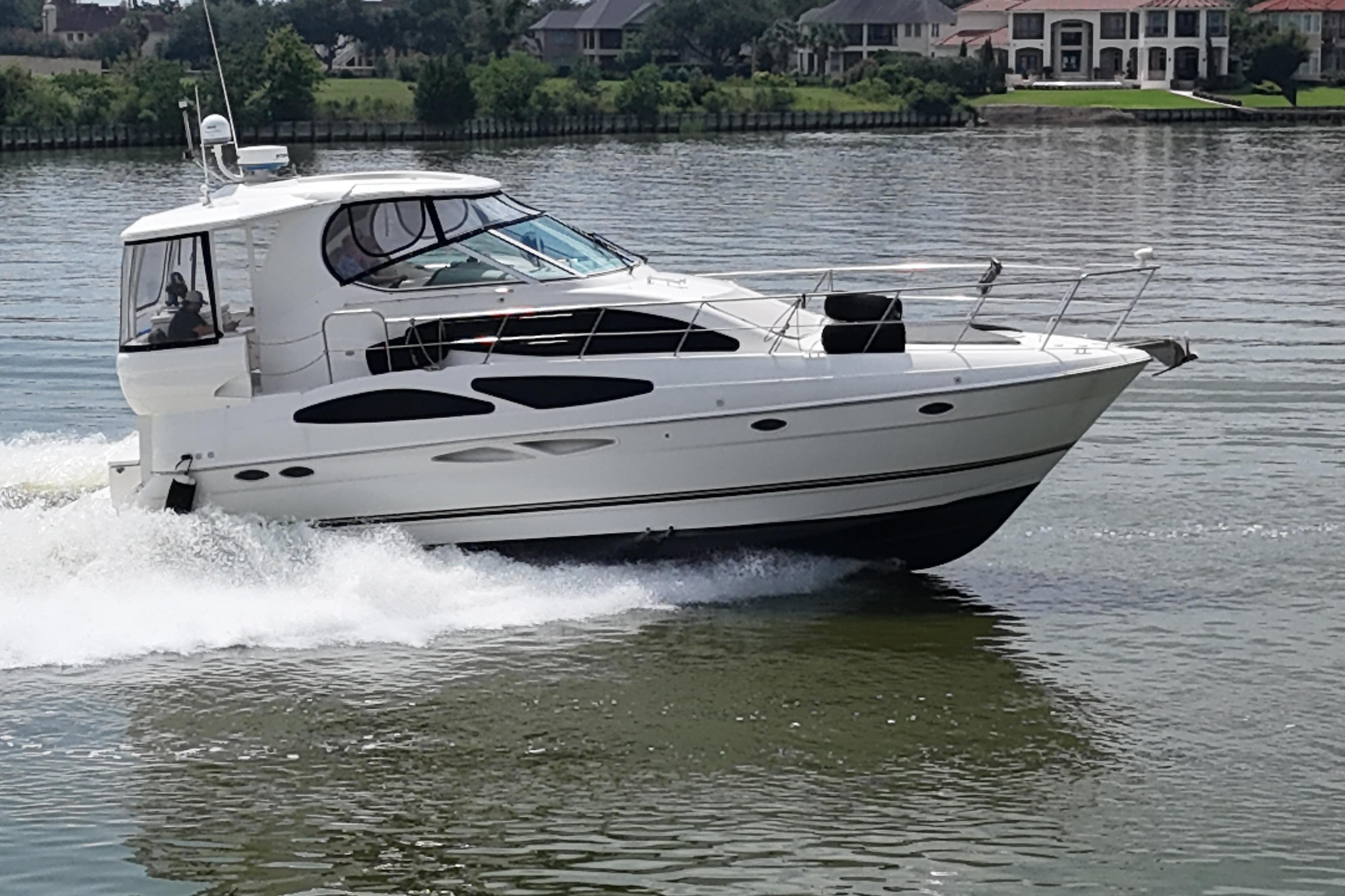 2004 Cruisers Yachts 405 Express Motoryacht cruising on a serene lake.