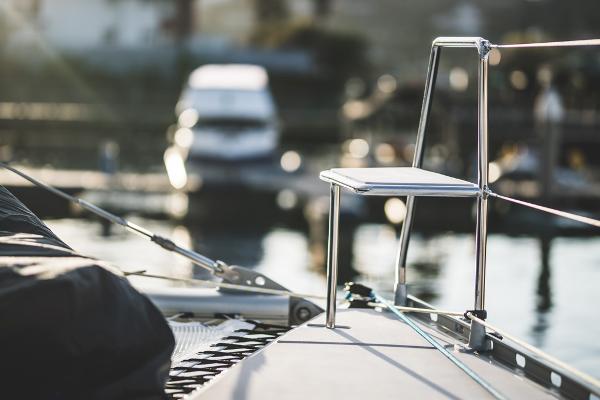 Sleek Vision 444 yacht deck with modern chair, 2025 model, docked at marina.