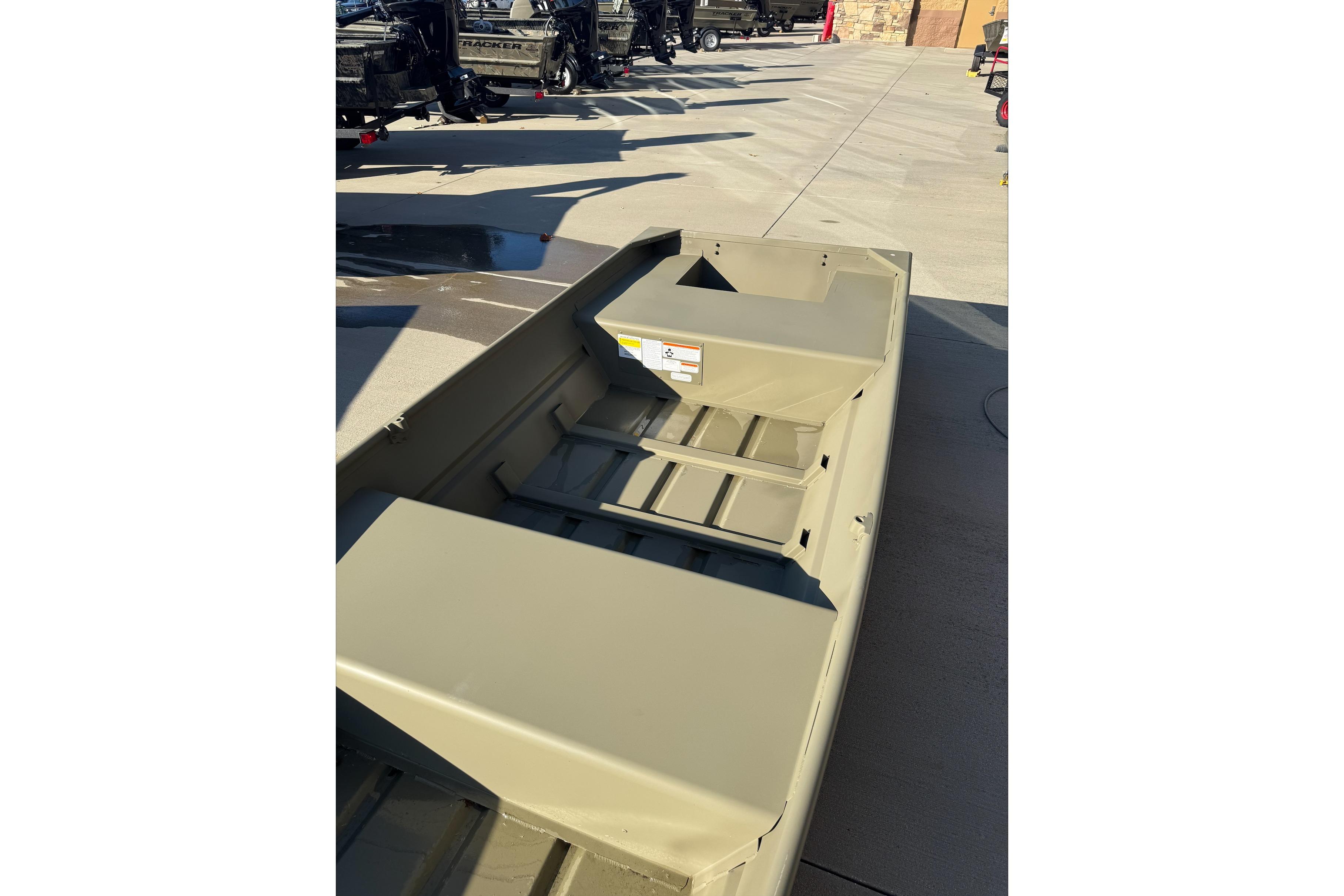 2026 Tracker Grizzly 14 Jon boat displayed outdoors, showcasing its sturdy design and spacious interior.