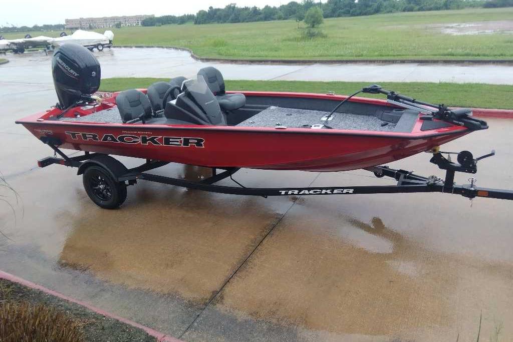 2026 Tracker Pro Team 175 Crappie Edition boat on trailer, parked on wet pavement.