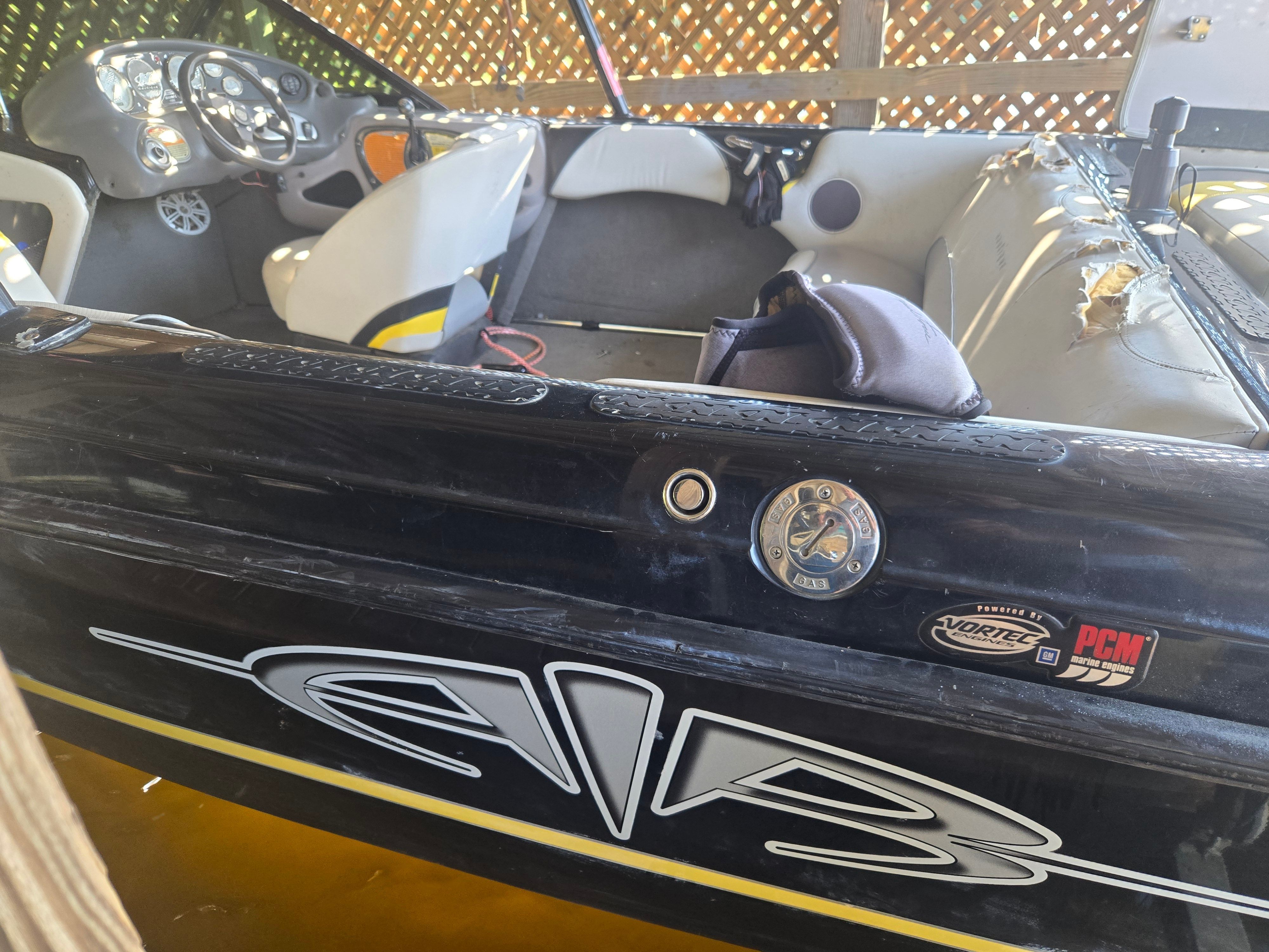 The image shows the interior of a 2003 Correct Craft Air Nautique boat with a steering console.