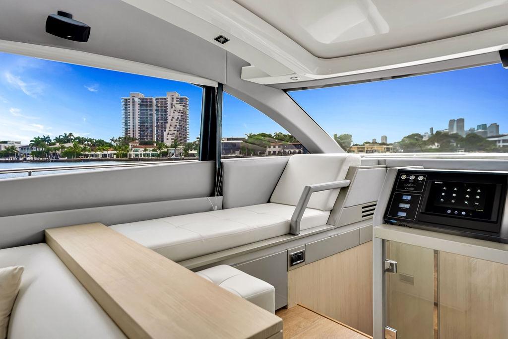 Luxurious interior of 2012 Fairline Targa 58 yacht with modern seating and control panel.