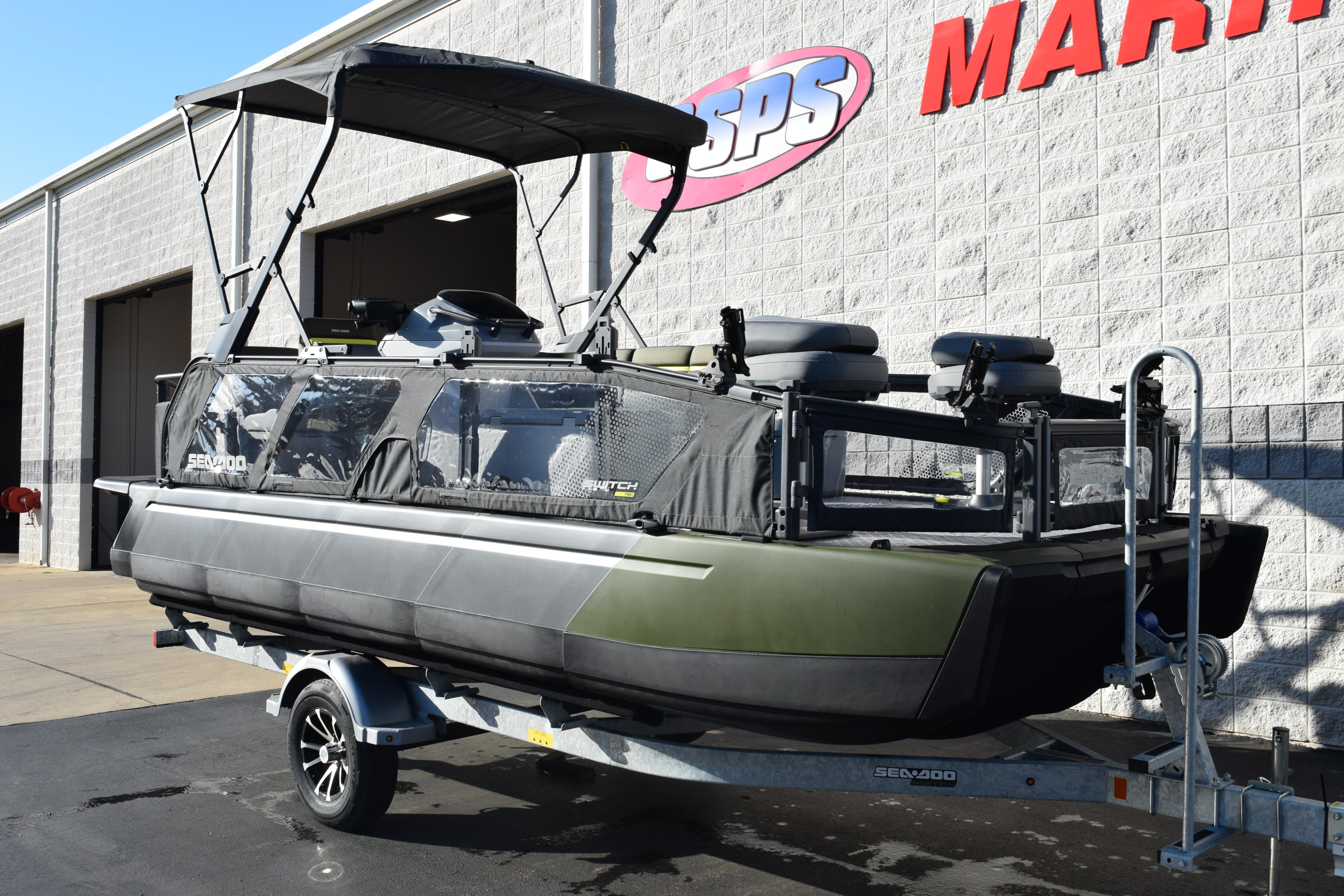 2026 Sea-Doo Switch Fish 21 pontoon boat on trailer outside marine shop.