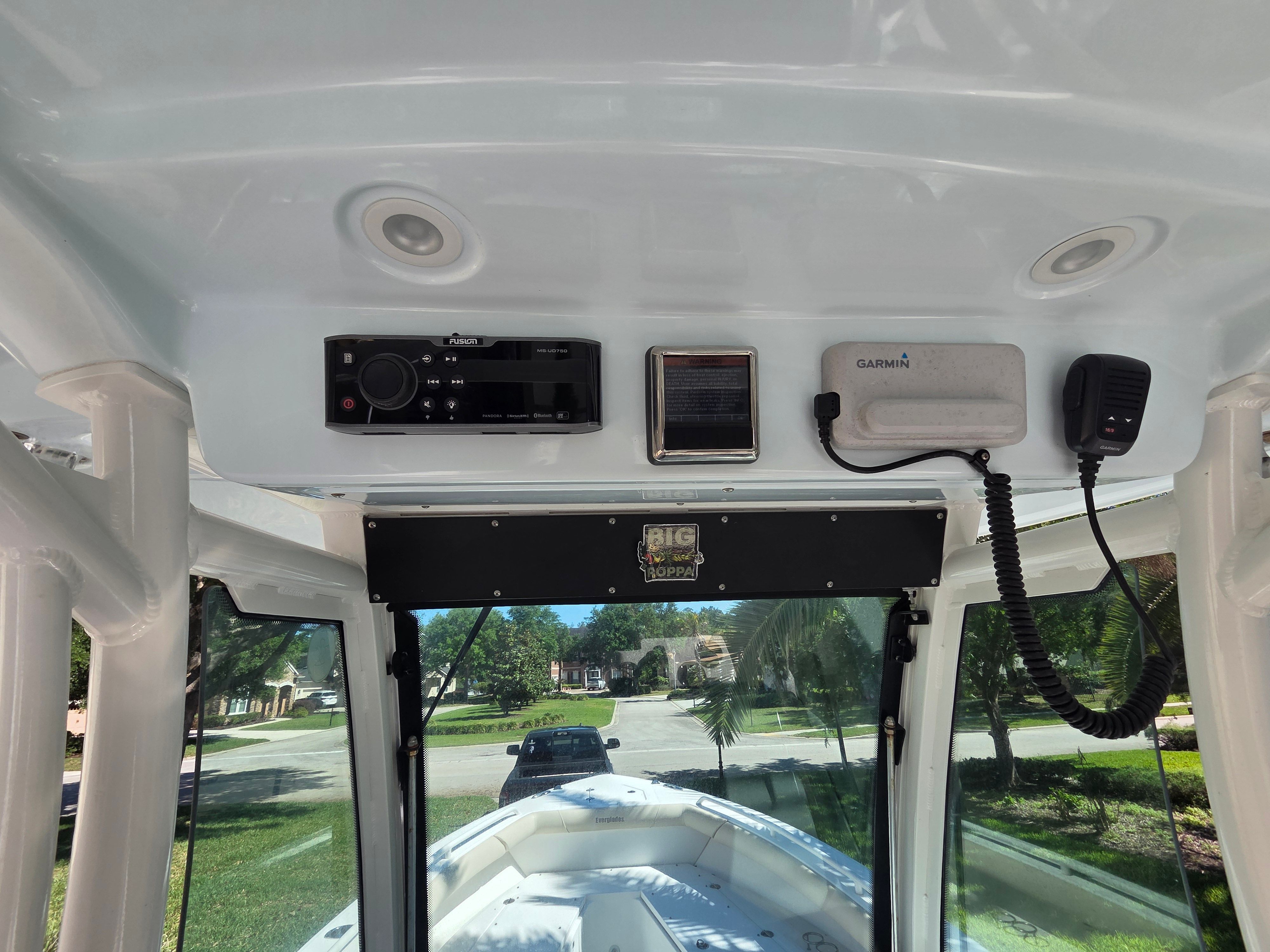 The image shows the cockpit of a 2017 Everglades 273 Center Console boat. There are electronic devices and controls on the ceiling.