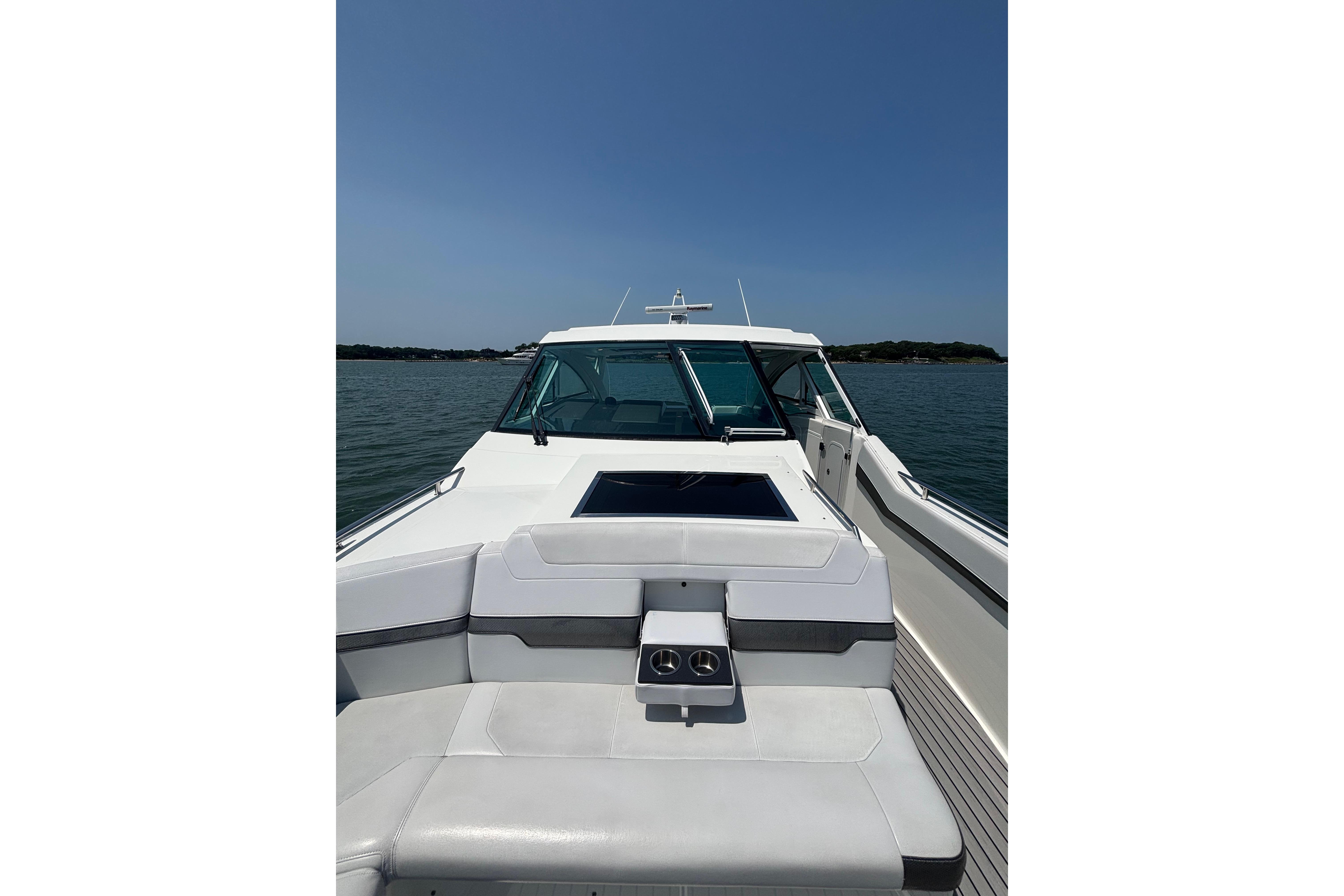2019 Formula 430 Super Sport Crossover boat on calm water under clear blue sky.