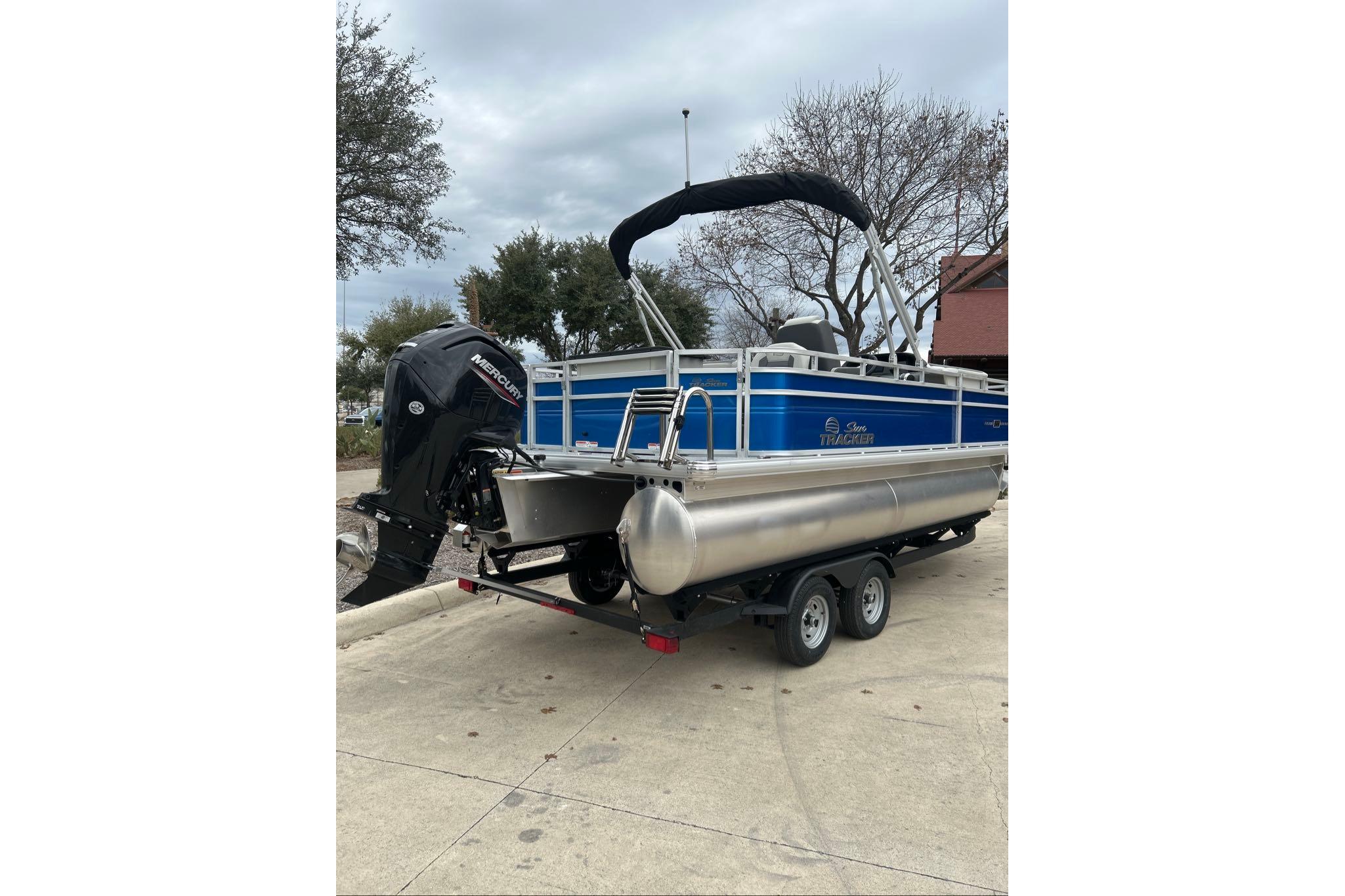 2026 Sun Tracker Fishin' Barge 20 DLX pontoon boat with Mercury outboard motor.