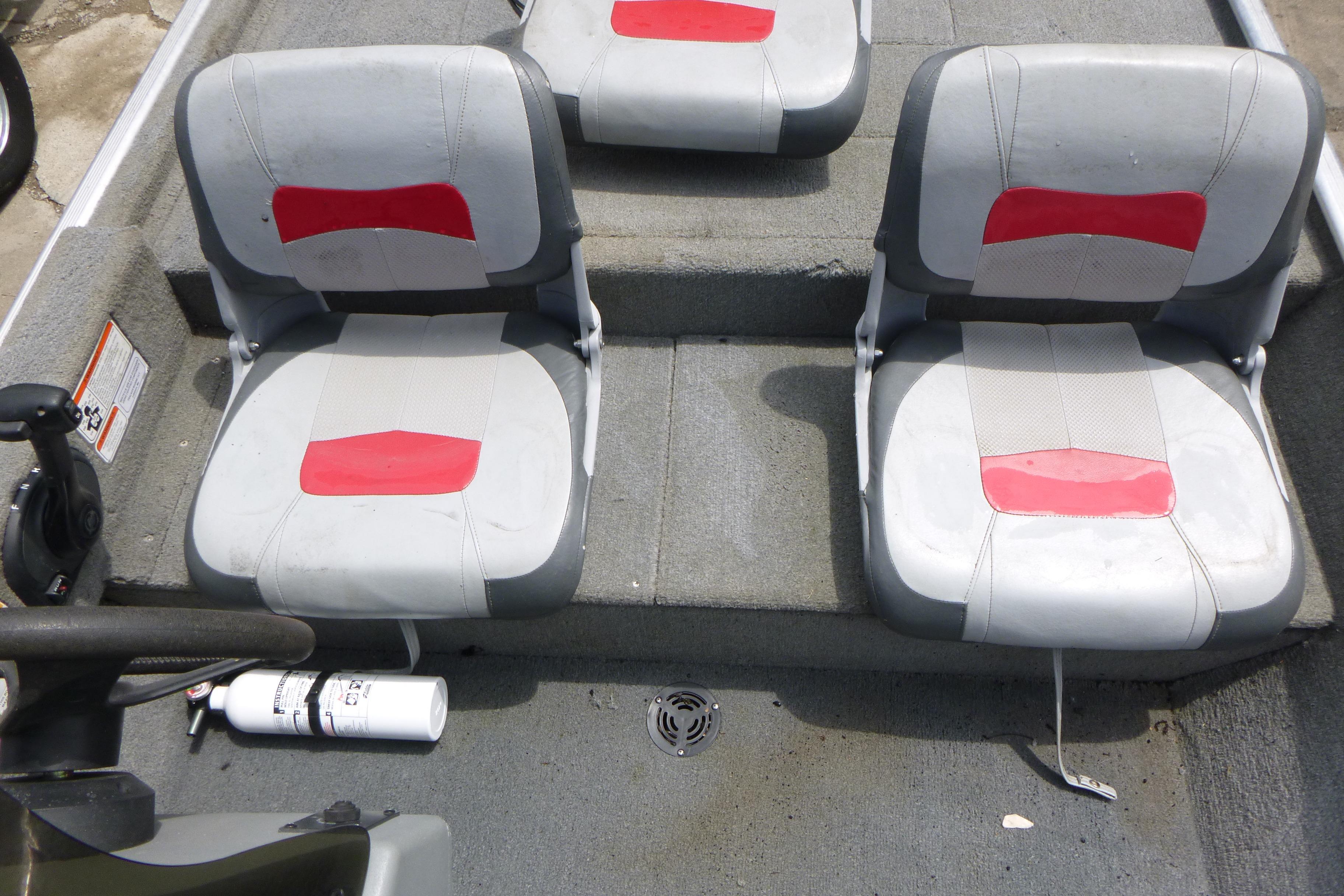 2011 Tracker Pro Angler 16 boat interior with two gray and red seats.