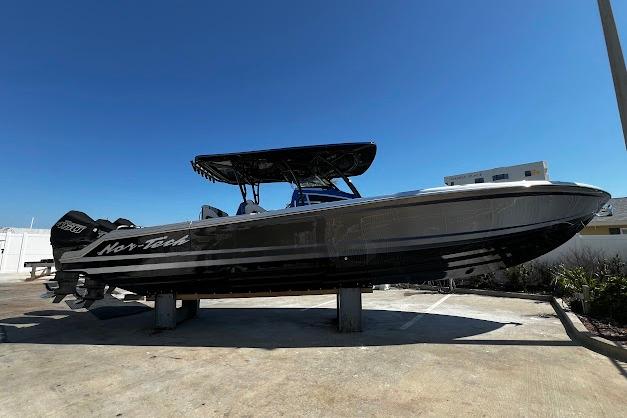 2022 Nor-Tech 390 Sport Center Console boat on display under clear blue sky.