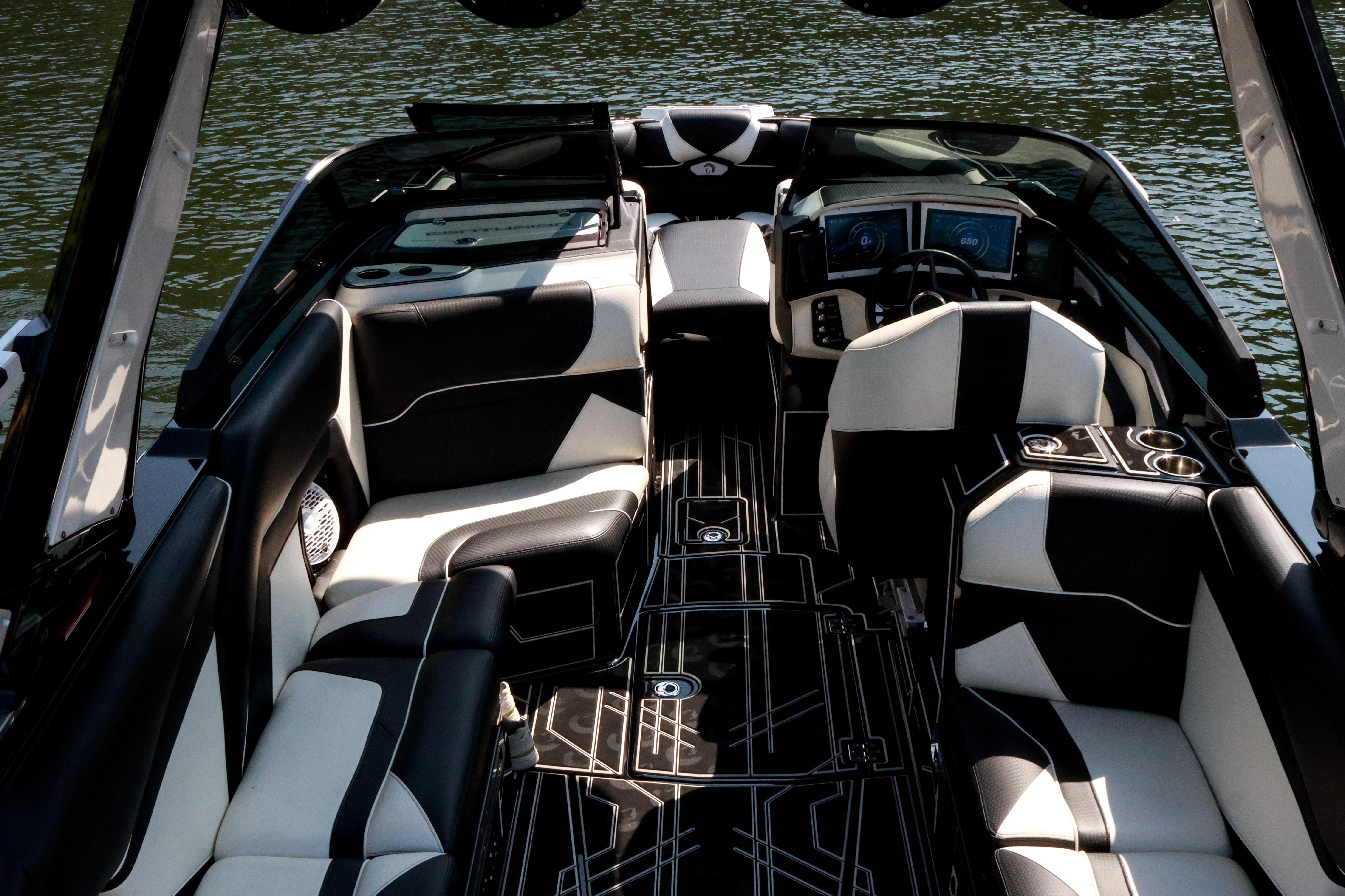 2022 Centurion Ri265 boat interior with black and white seating, sleek design, and modern dashboard.