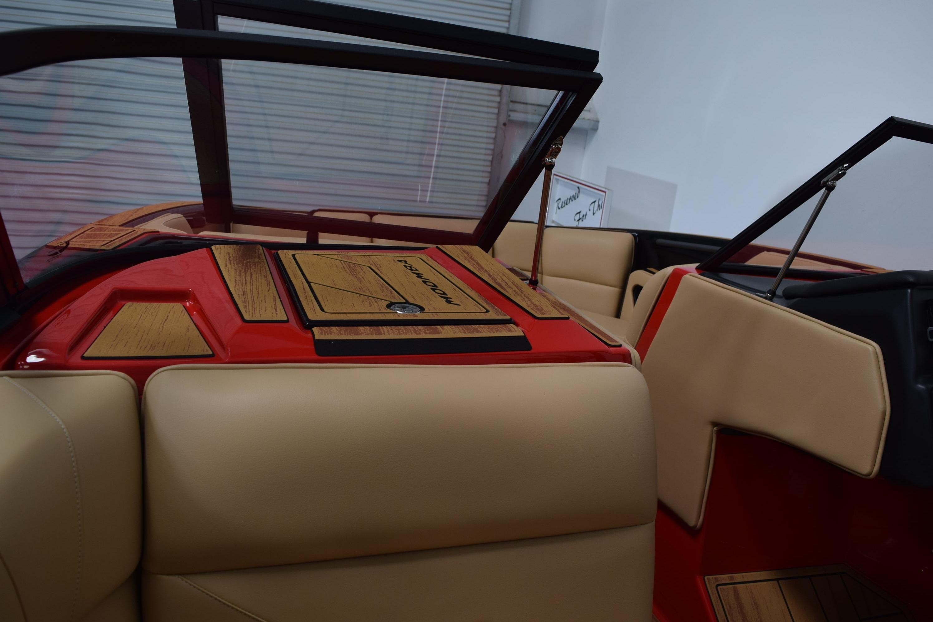 2026 Moomba Max boat interior with beige seats and red accents.