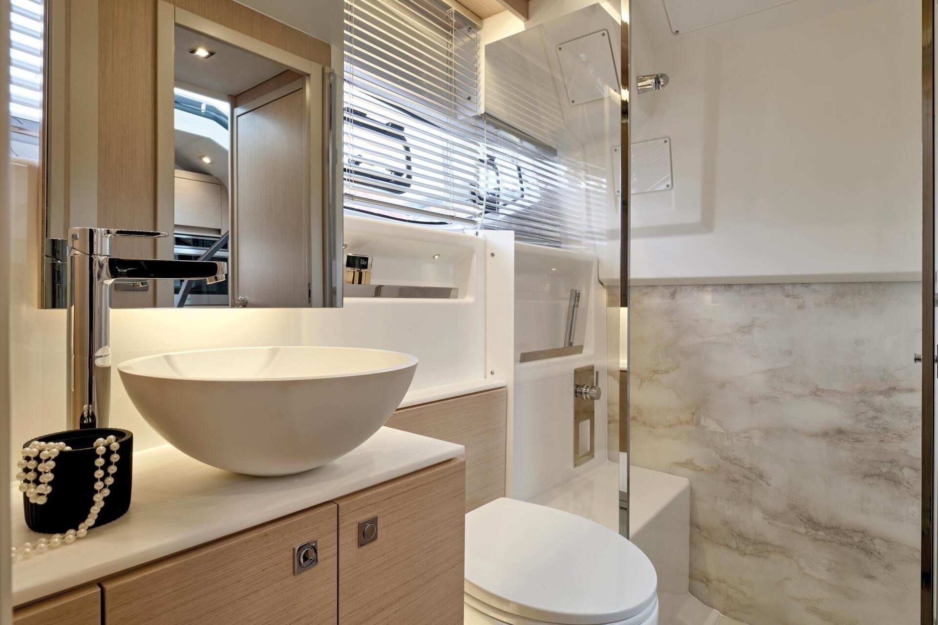 Luxurious bathroom interior of 2027 Jeanneau DB/43 OB yacht with modern fixtures.