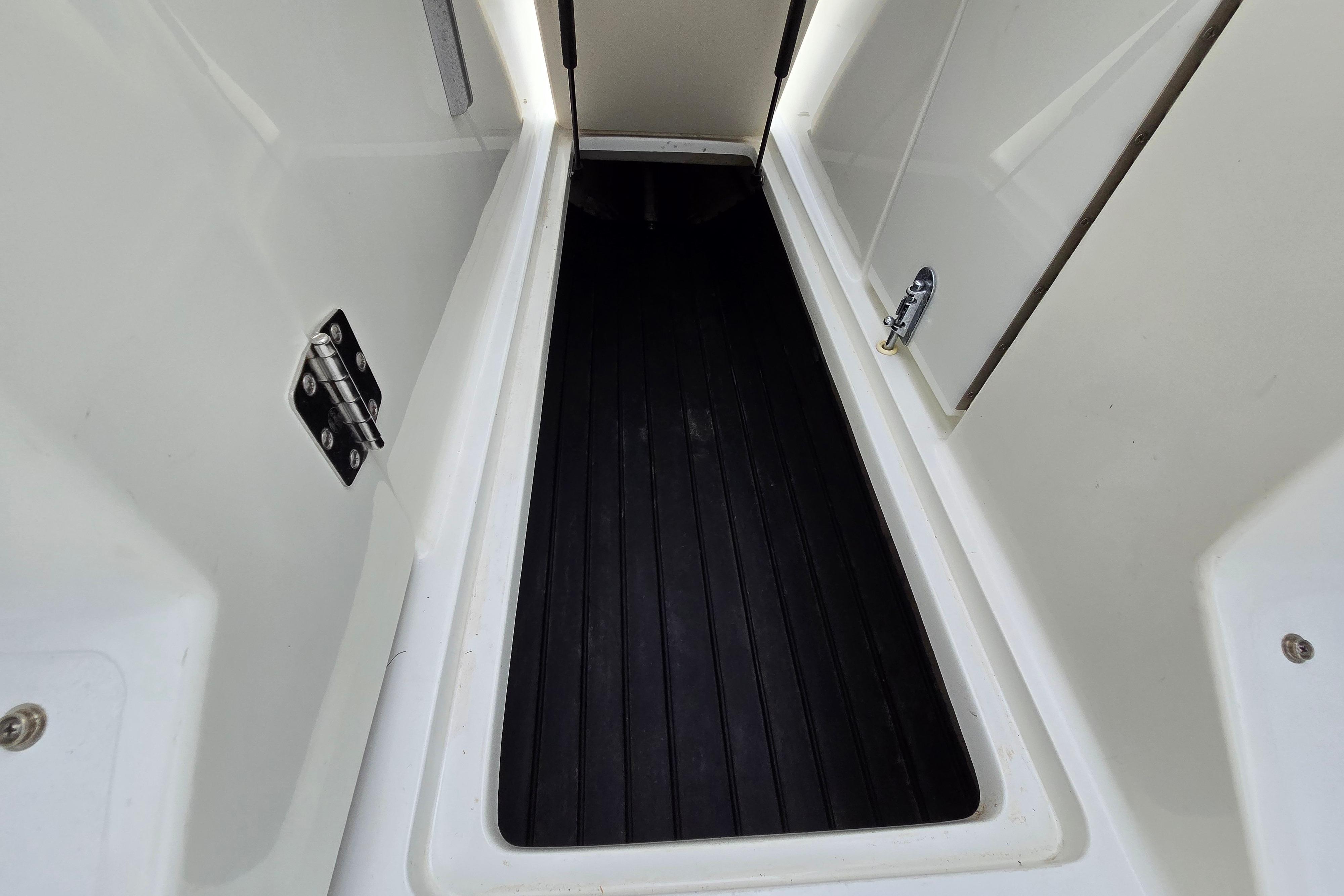 Interior view of a 2000 Cobalt 246 boat compartment with black flooring.