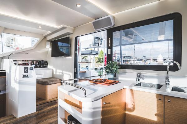 Luxurious Vision 444 yacht interior, featuring modern kitchen and helm, 2025 model.