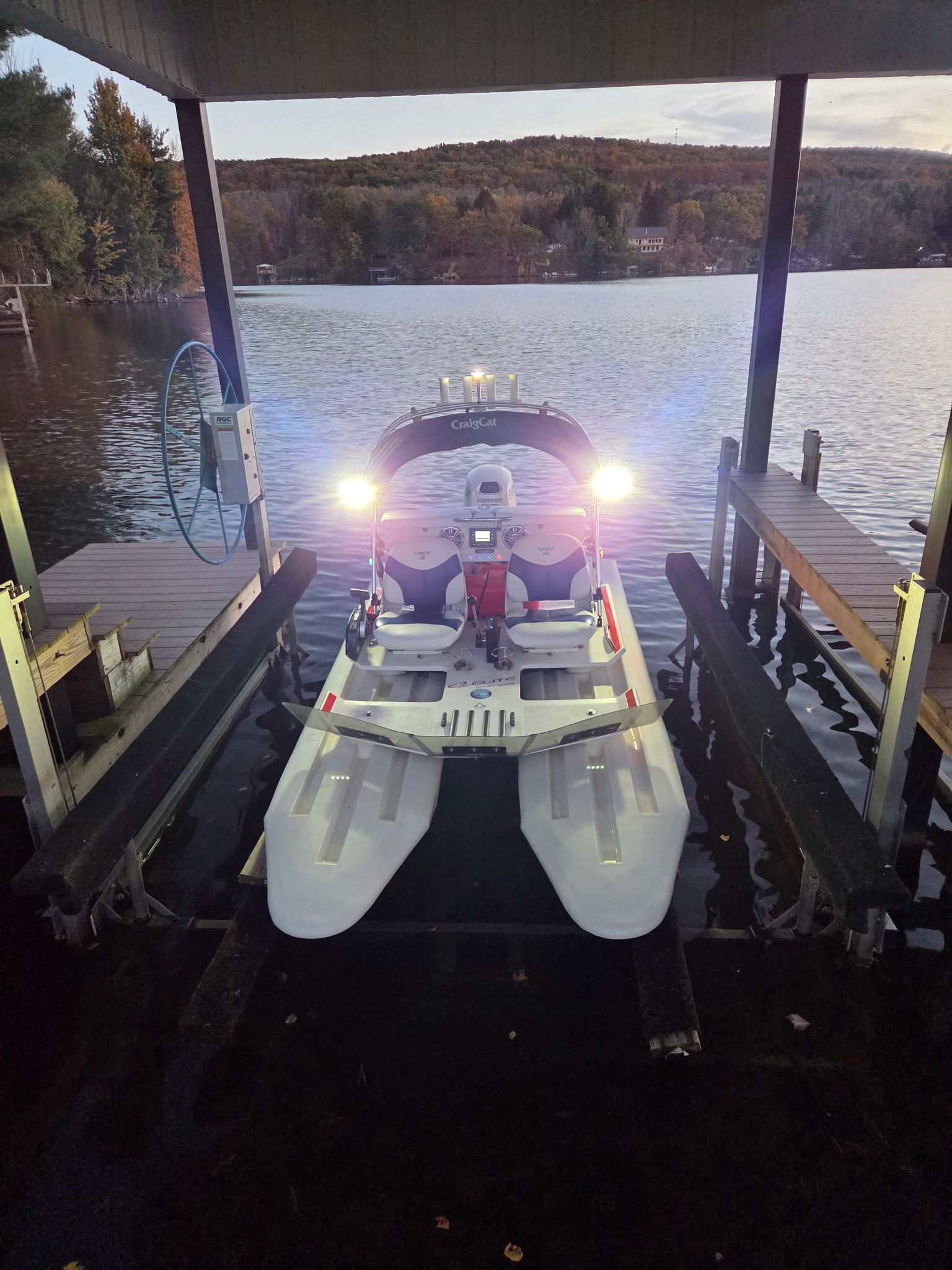 A 2018 CraigCat Elite is docked on a calm lake.