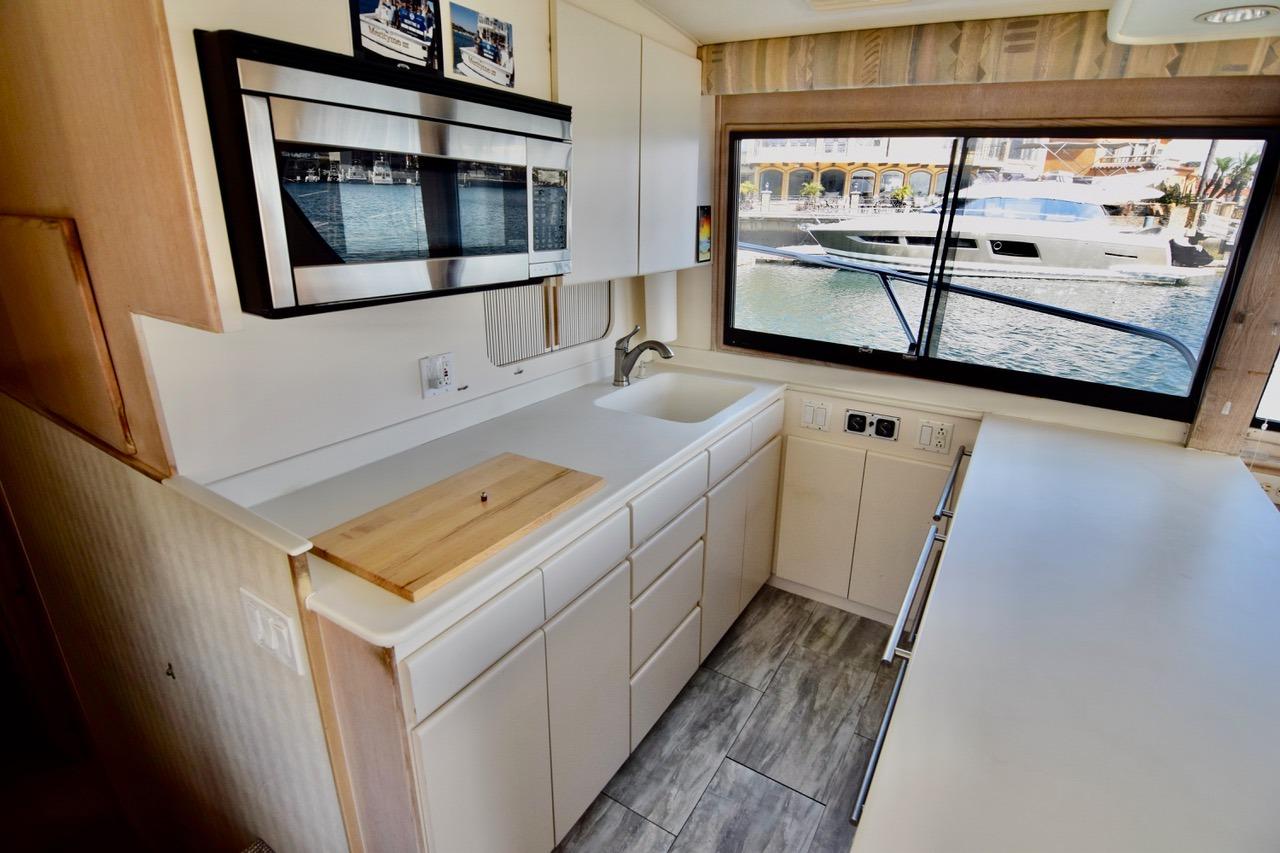 Interior of 1995 Hatteras 50 Convertible yacht kitchen with modern appliances and waterfront view.