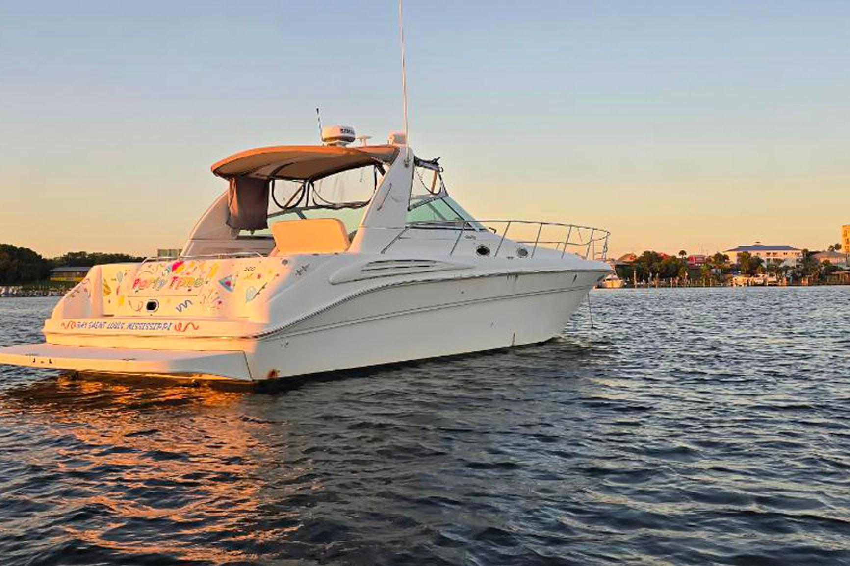 1998 Sea Ray Sundancer 400 yacht on calm water at sunset, showcasing elegant design.