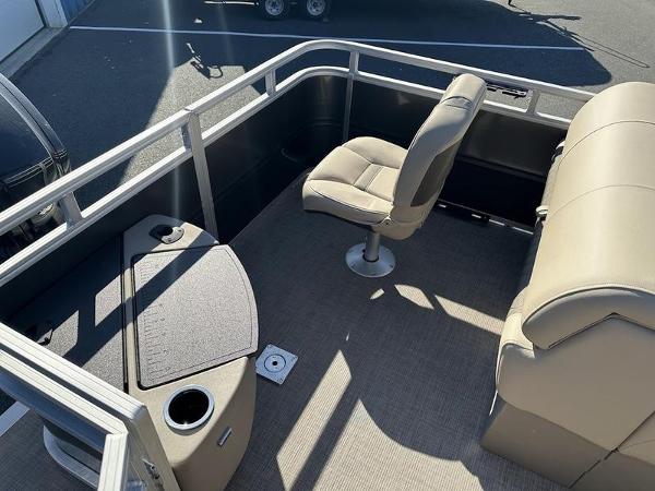 2025 Sun Tracker FB 20 DLX pontoon boat interior with beige seating and table.