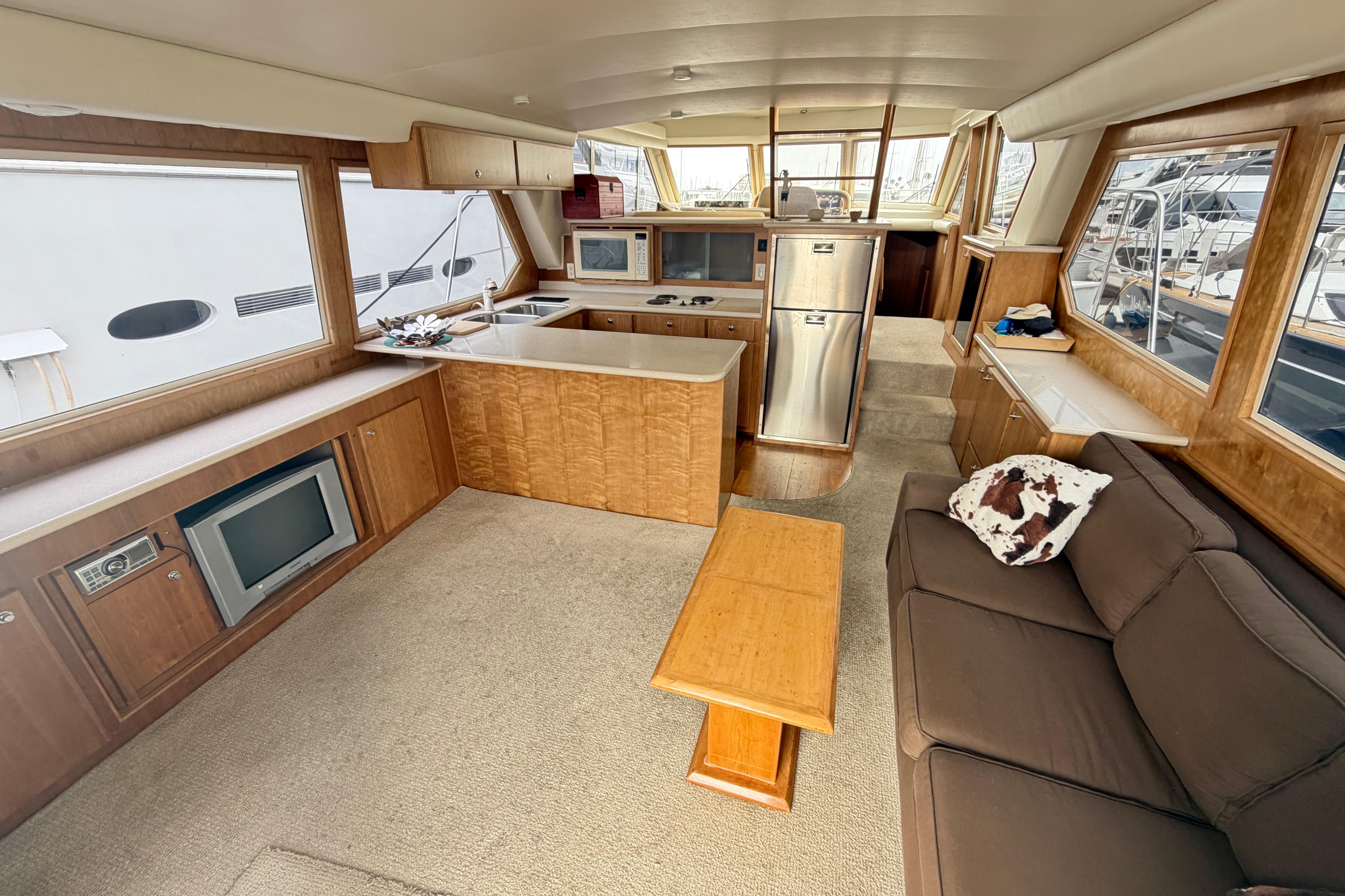 Luxurious interior of 2005 Navigator 53 Pilot House yacht with modern kitchen and cozy seating area.