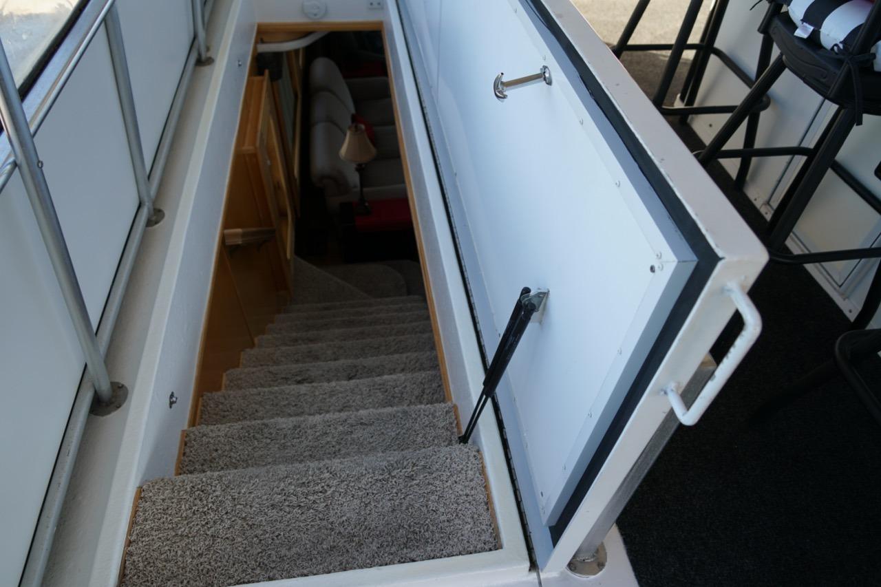 Staircase leading below deck on 2000 Stardust Cruisers 83'x17' houseboat.