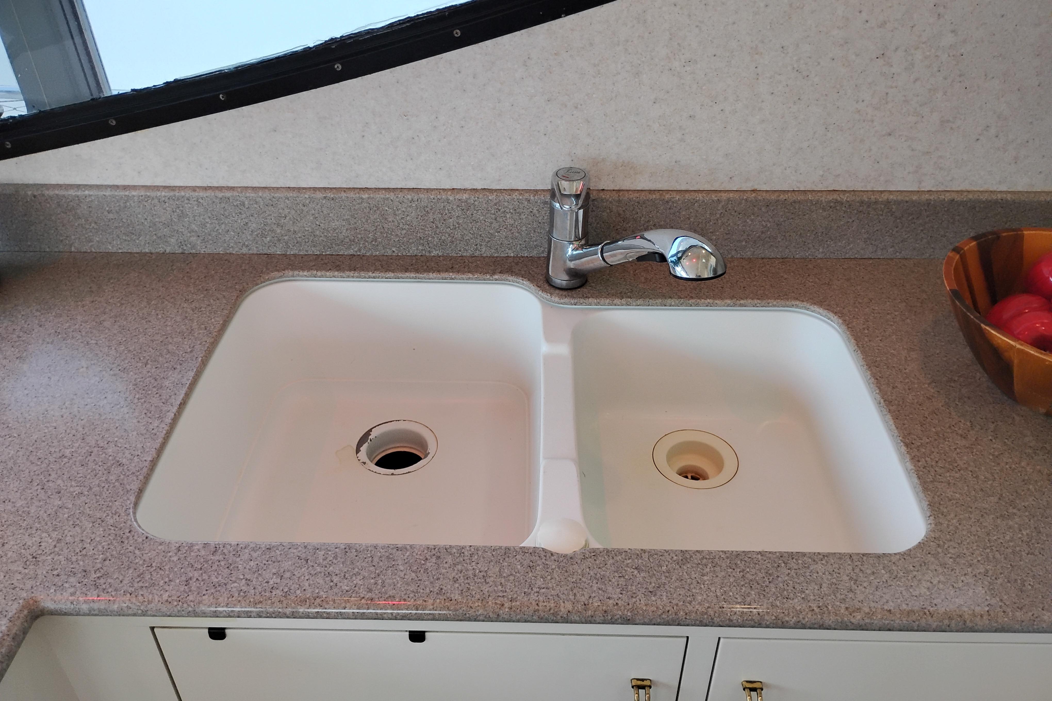 Kitchen sink and faucet on 1995 Queenship 62 Pilothouse Motor Yacht.