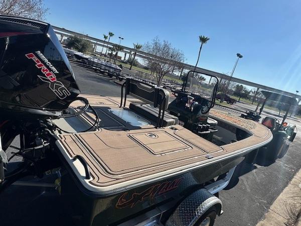 2025 Mako 18 Pro Skiff Backwater Edition boat with powerful engine, parked outdoors.