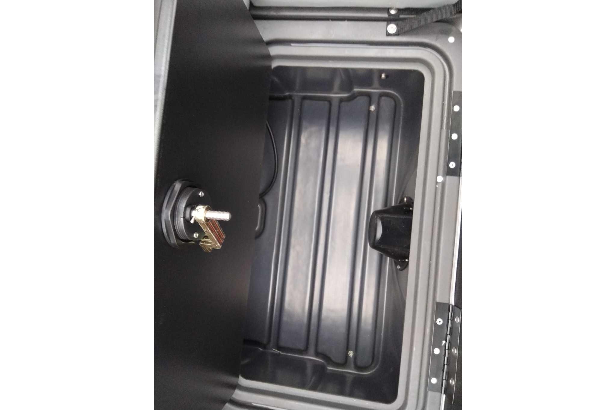 Storage compartment of 2026 Sun Tracker Party Barge 22 XP3 with key lock mechanism.
