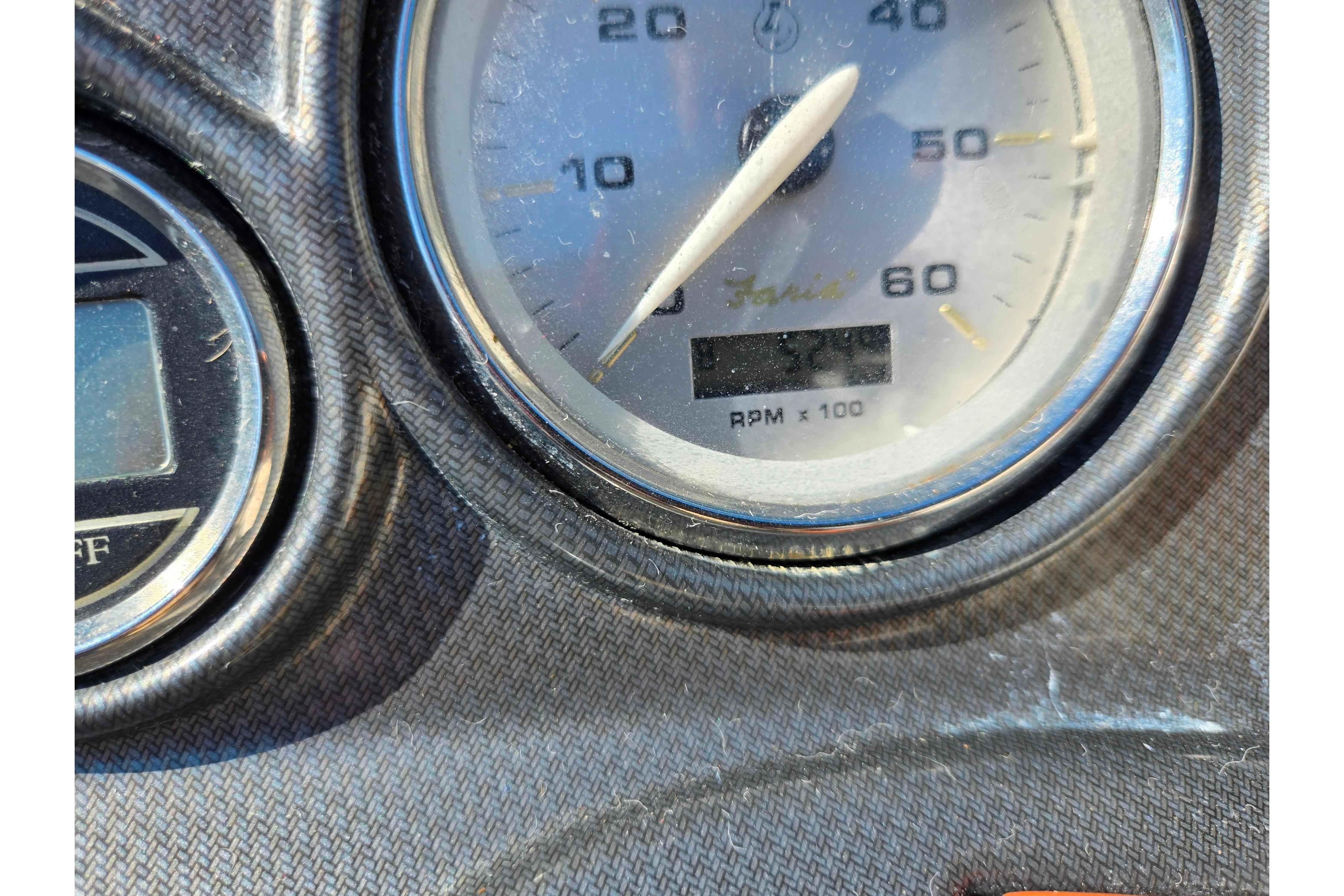 Close-up of 2007 Rinker 246 Captiva Cuddy boat dashboard gauges.