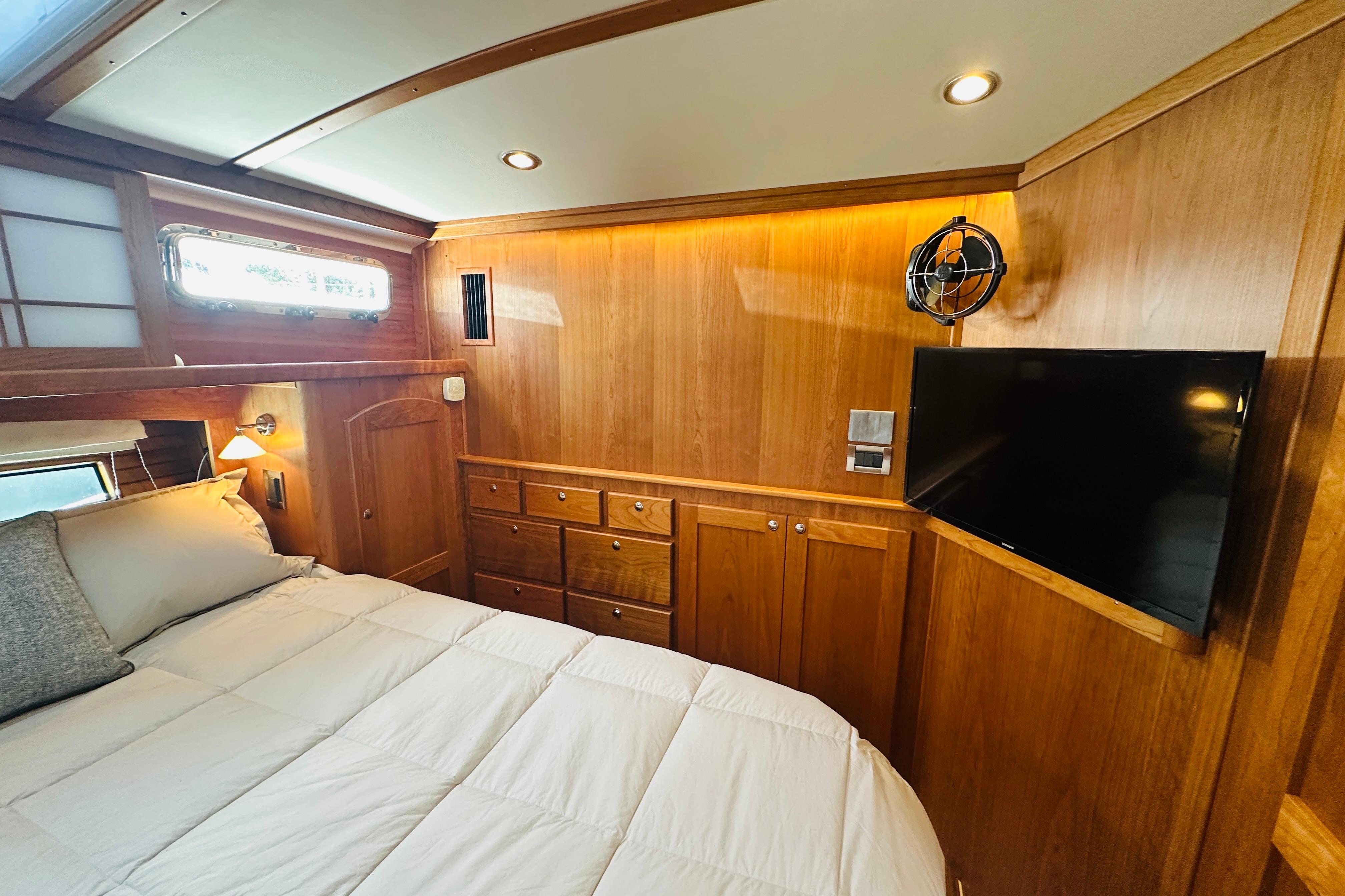 Luxurious 2025 Sabre 48 Salon Express cabin with wood paneling and modern amenities.