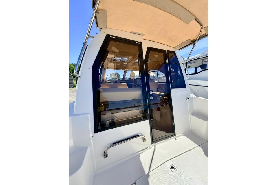 2017 Cutwater C-242 Coupe boat with glass doors and canopy, showcasing interior seating.