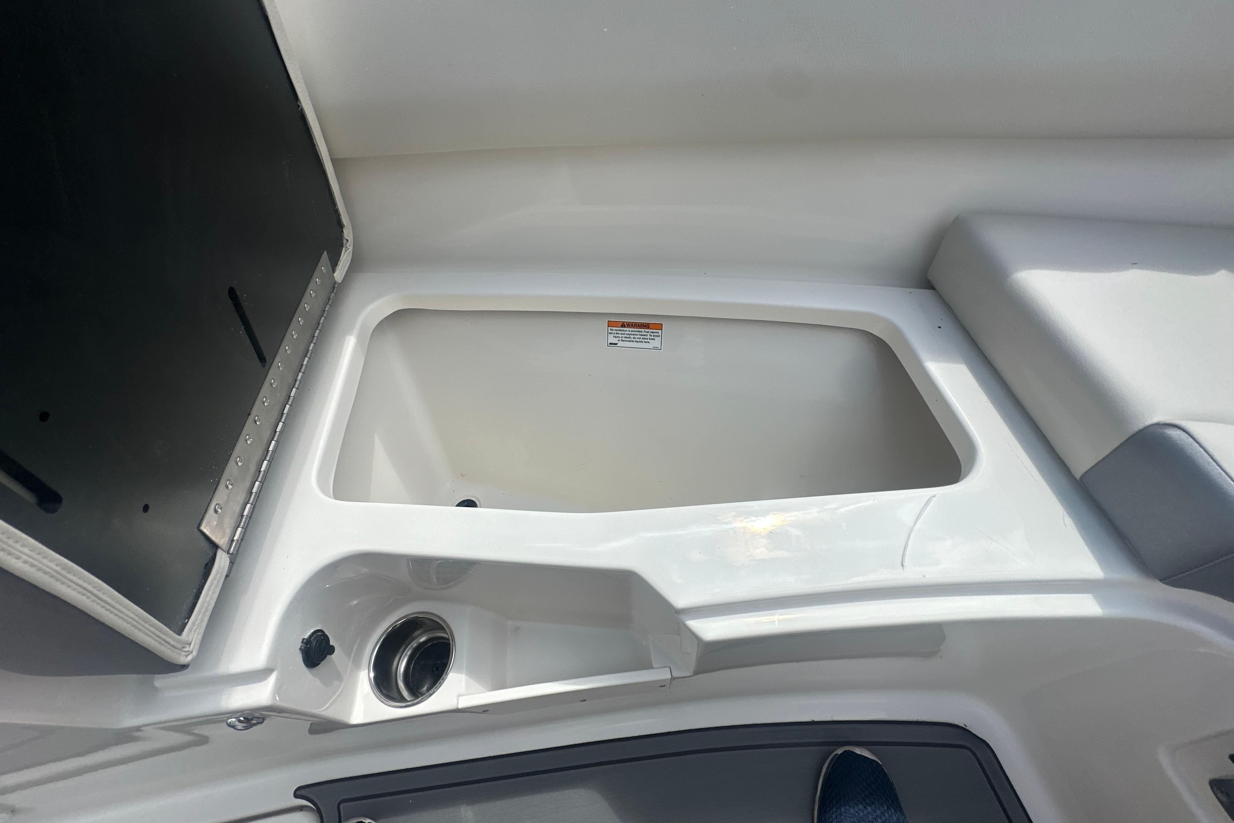 Open storage compartment on 2026 Sailfish 226 DC boat interior.