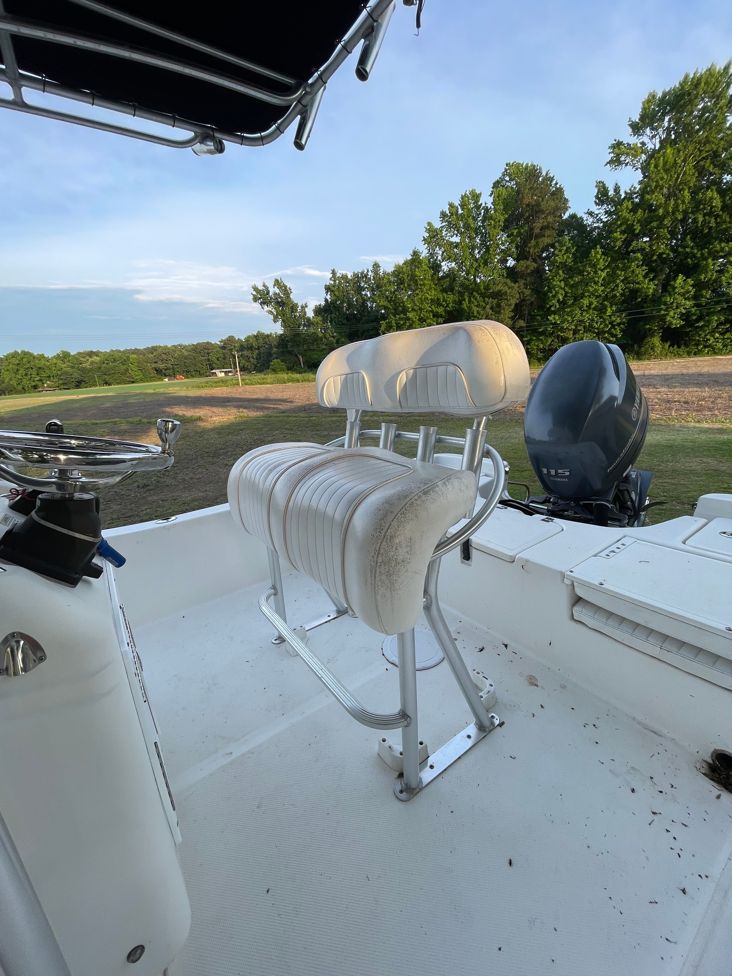 The image shows the cockpit of a Sea Fox 200XT boat with white seats and an outboard motor.