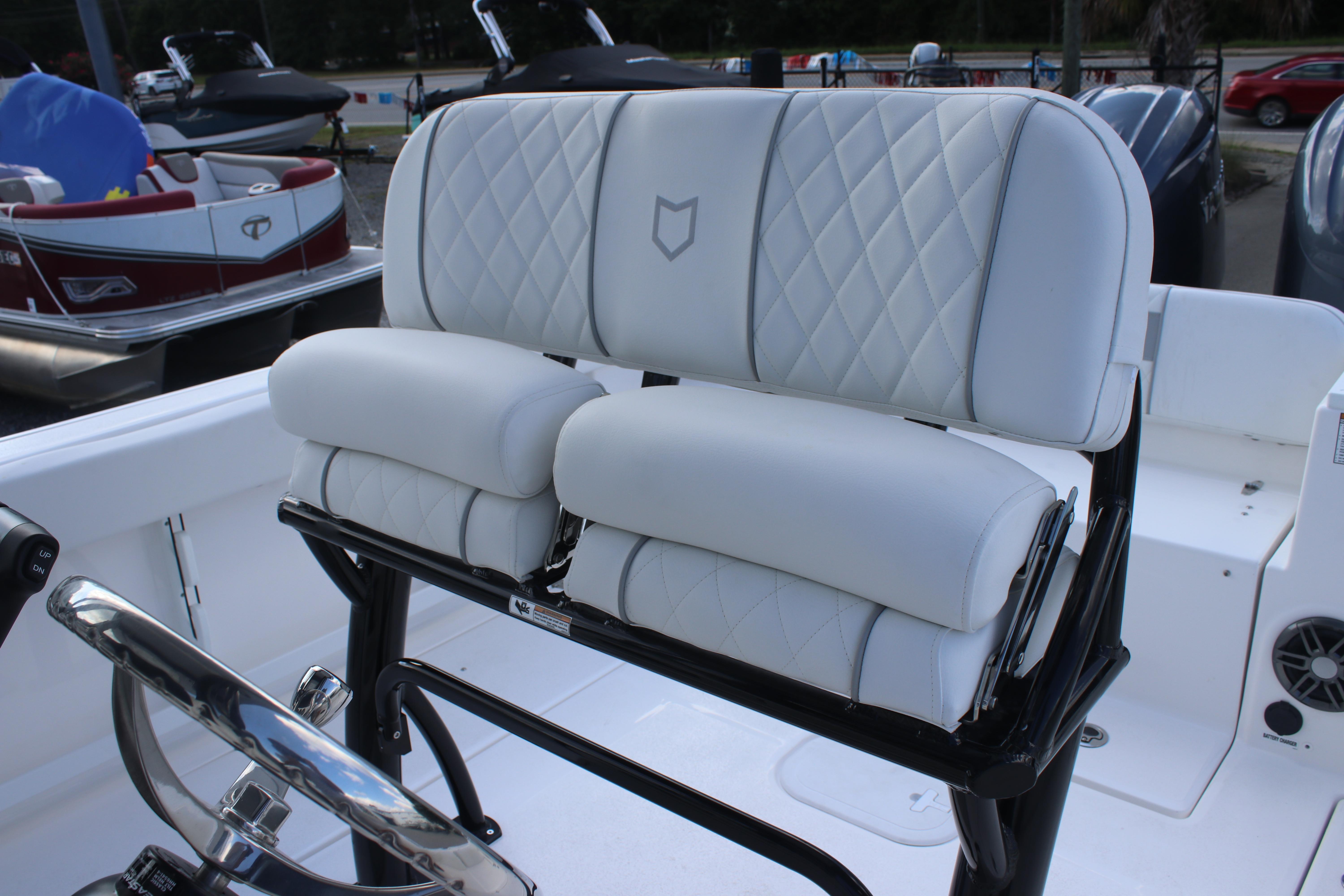 2026 Sea Fox 268 Commander boat with white cushioned seating and steering wheel.