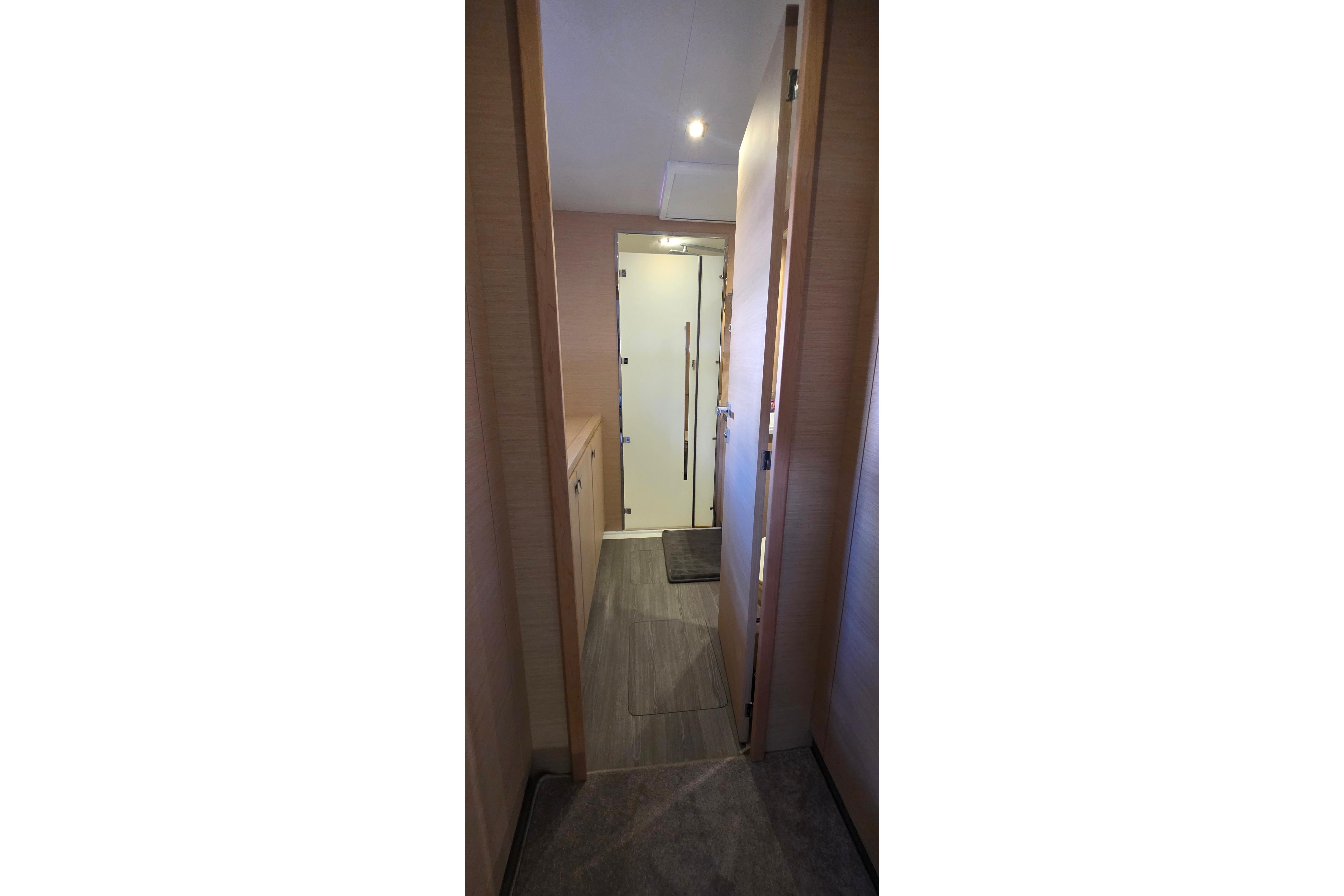 Hallway interior of 2018 Fountaine Pajot Motor Yacht 44, featuring modern wood paneling.