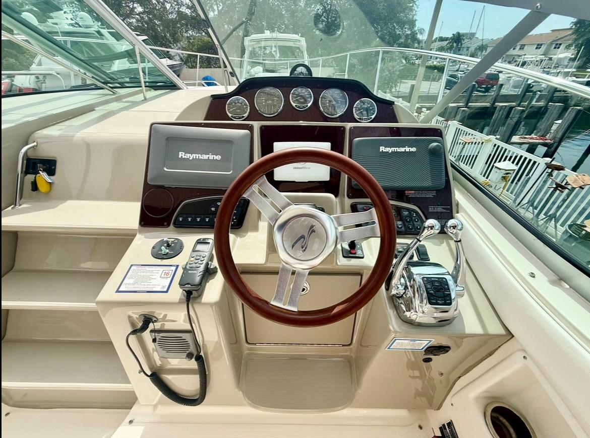 2011 Sea Ray 350 Sundancer helm with Raymarine electronics and polished steering wheel.