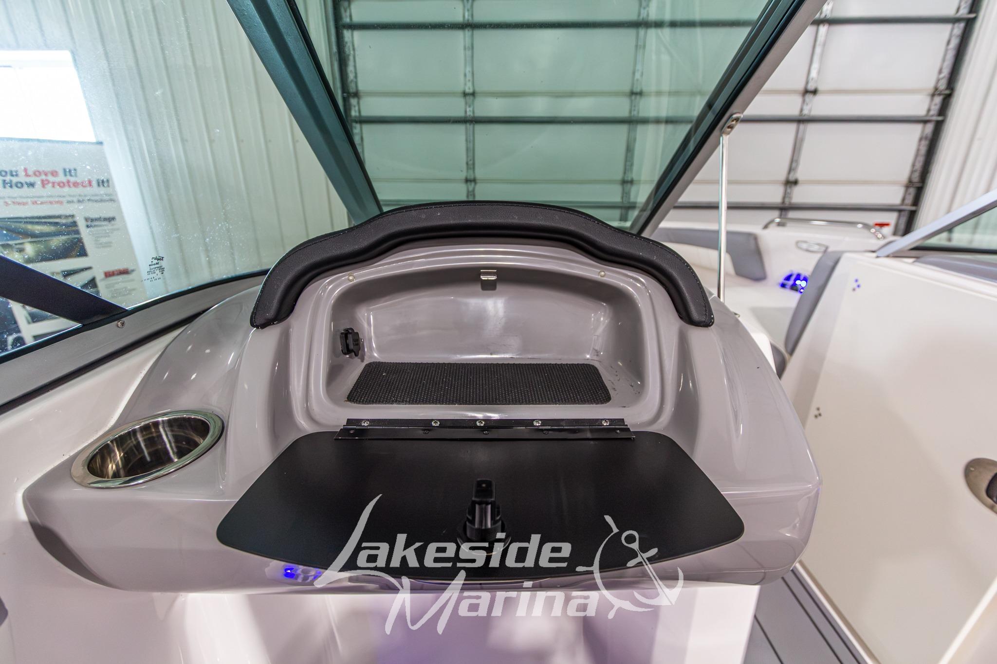 2022 Chaparral 21 SSi boat dashboard with storage compartment and cup holder at Lakeside Marina.