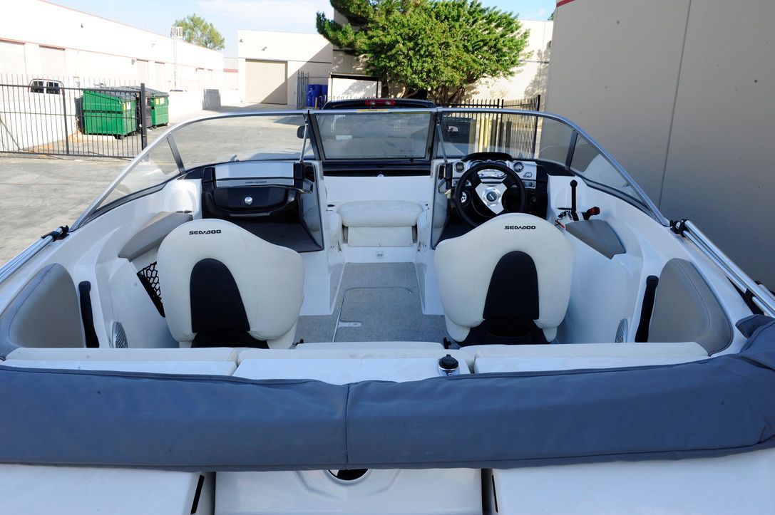 The image shows the cockpit of a 2011 Custom Challenger 180 boat with two seats.