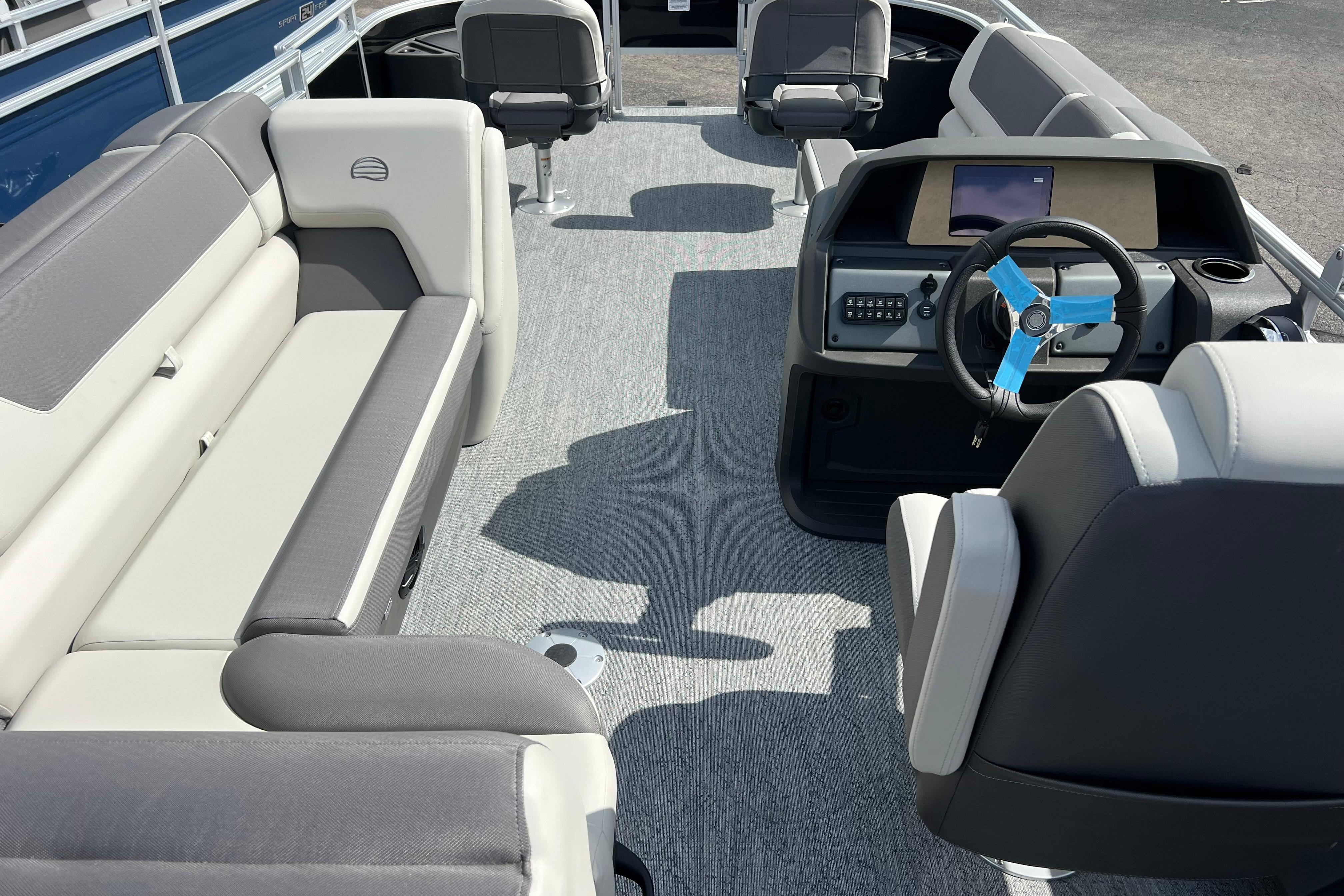 2026 Sun Tracker Fishin' Barge 22 DLX interior with seating and steering console.