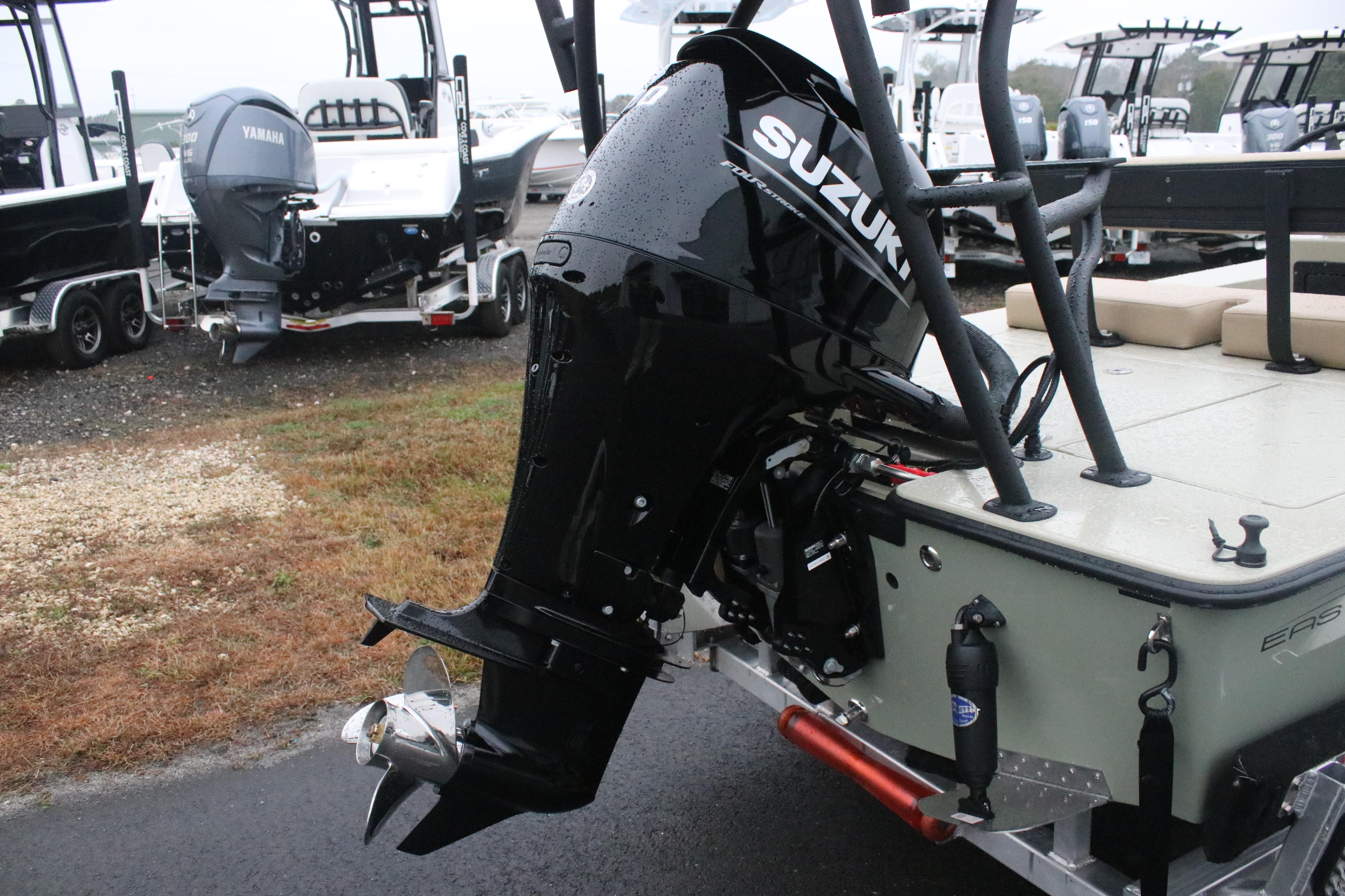 2026 East Cape EVO 18V boat with Suzuki outboard motor in a marina setting.