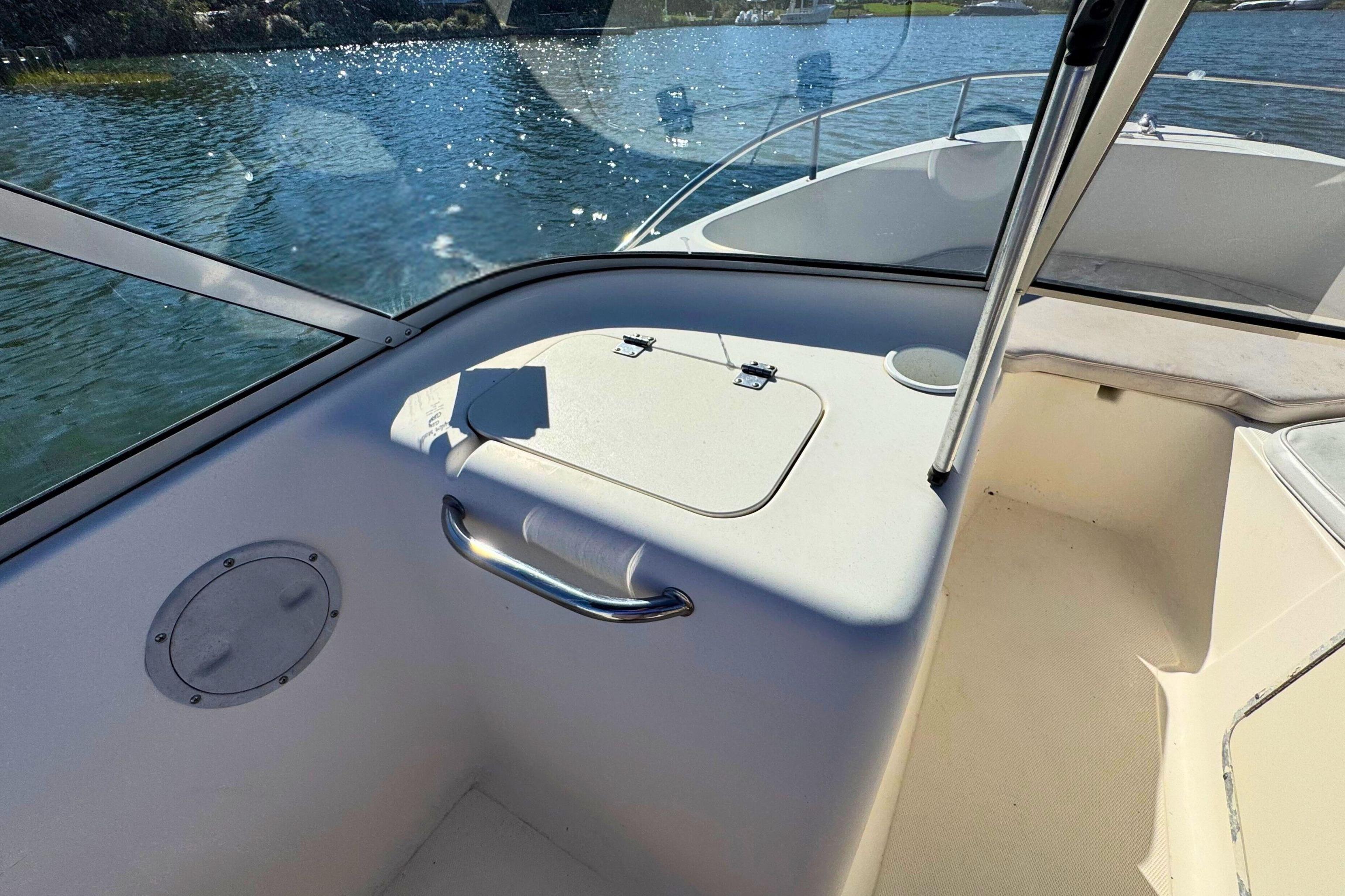 Interior view of a 2002 Sea Hunt Escape 200 boat, showing seating and storage.
