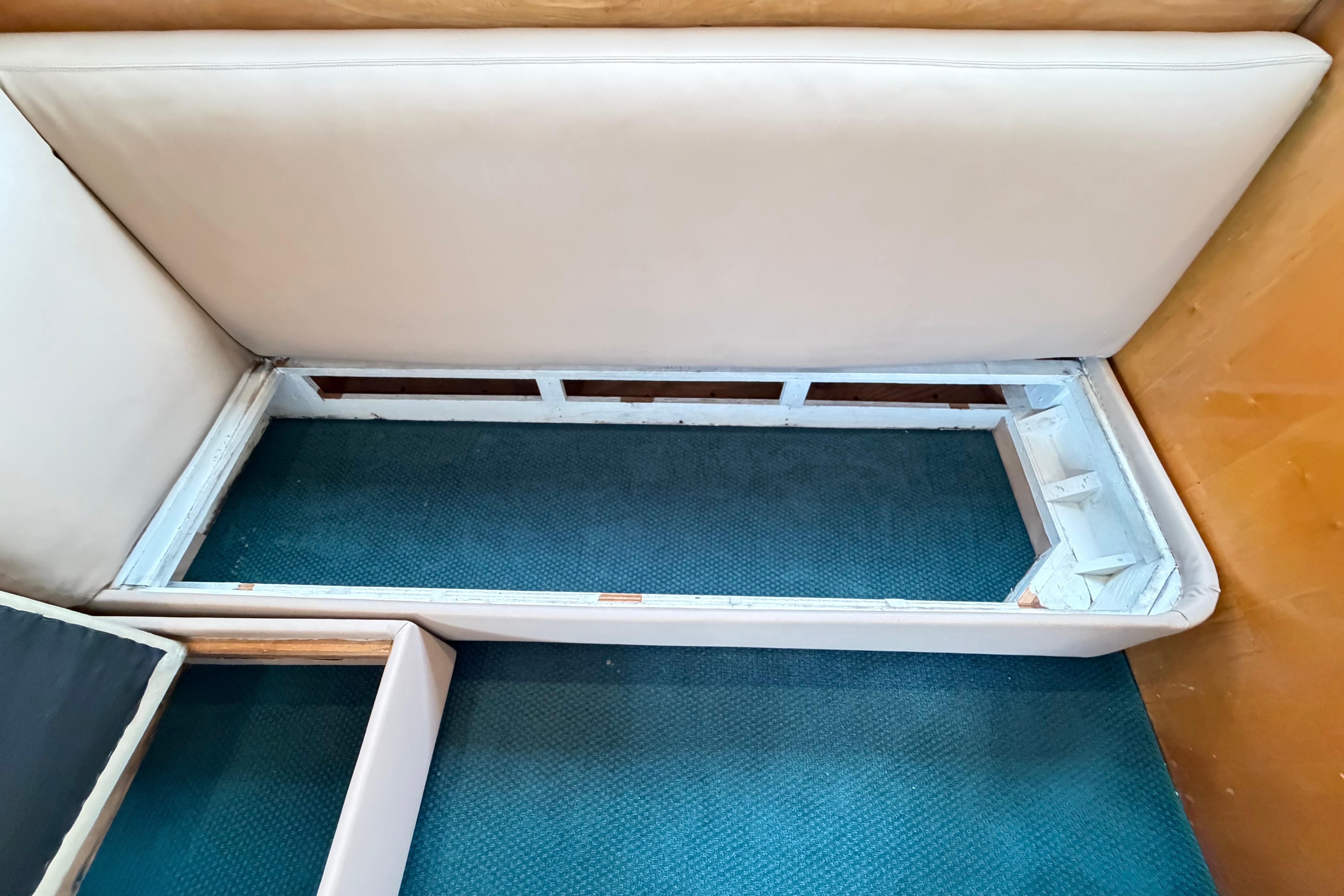 Interior seating area of a 1998 Blackwell Custom Carolina Sportfish boat, showing storage compartment.