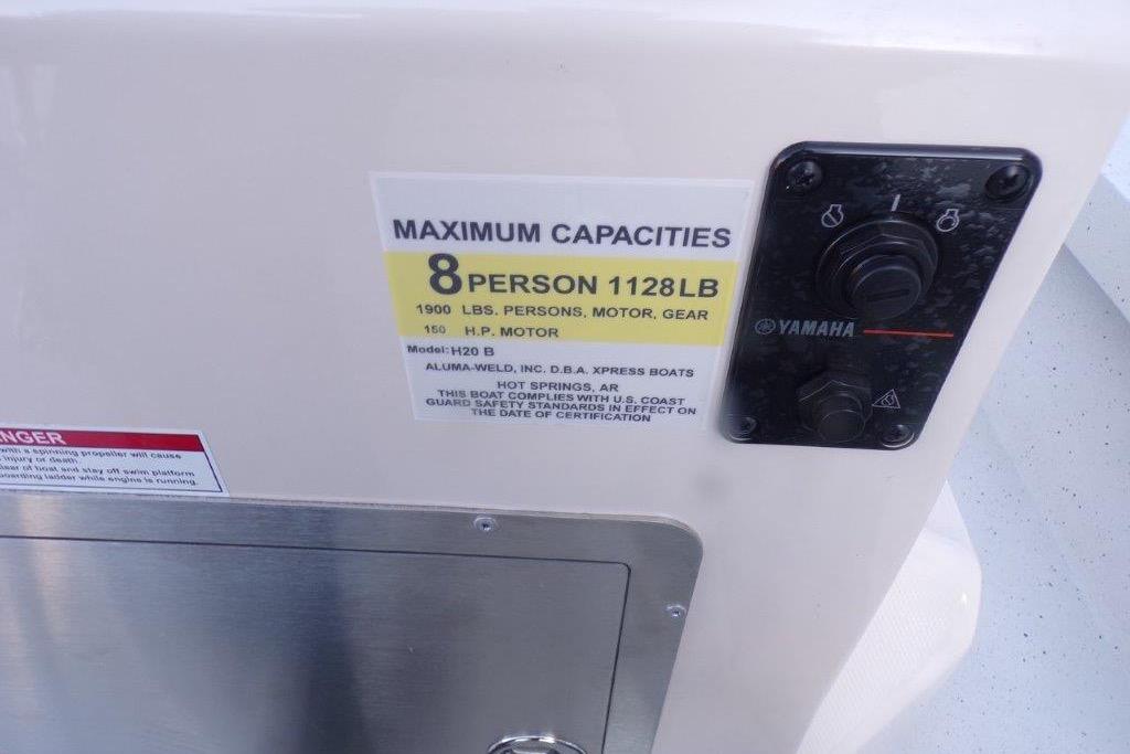 2026 Xpress H20B Bay boat capacity label, 8 persons, 1128 lbs, Yamaha controls.