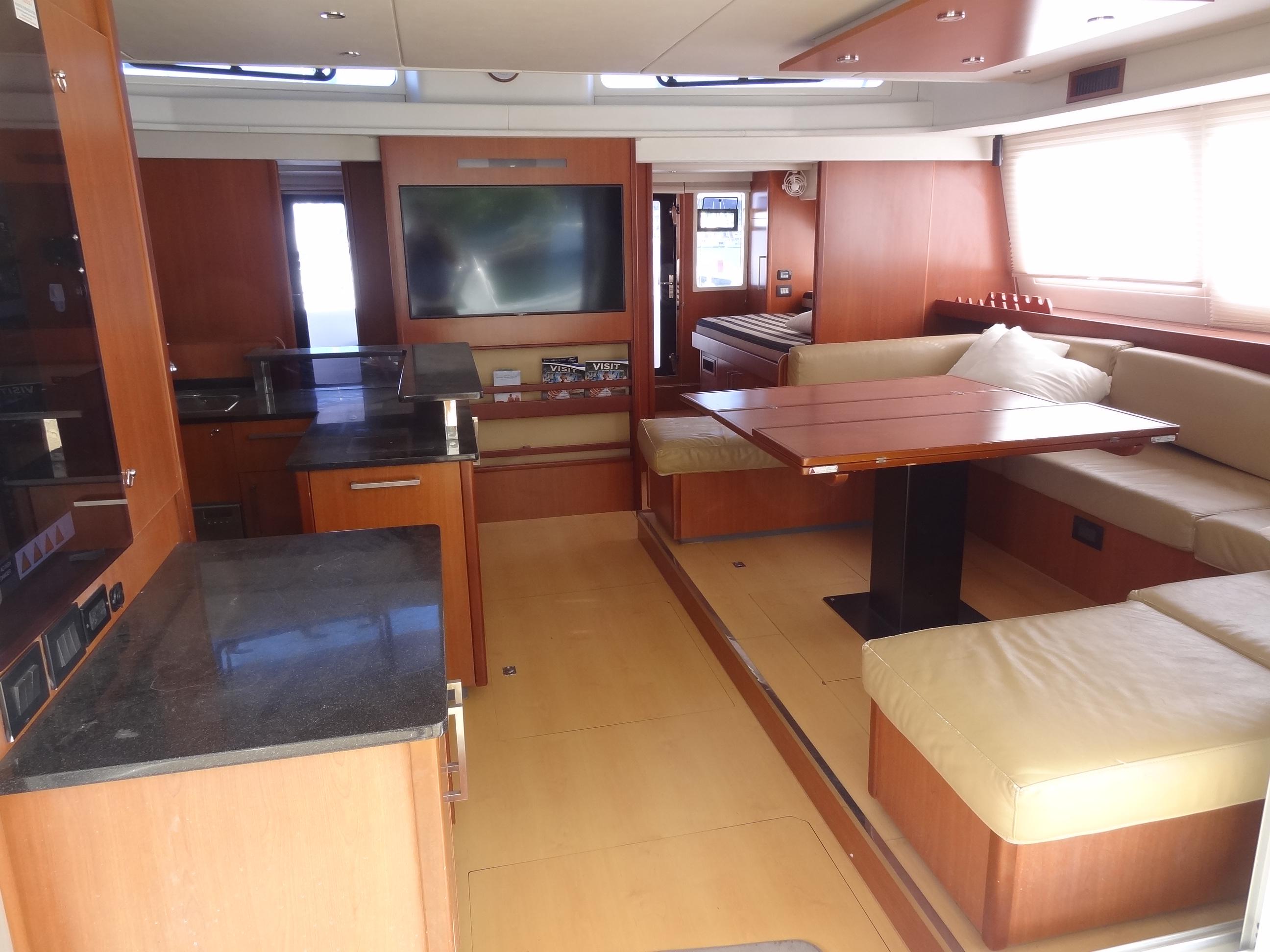 Luxurious interior of 2014 Leopard 58 yacht with modern kitchen and spacious seating area.