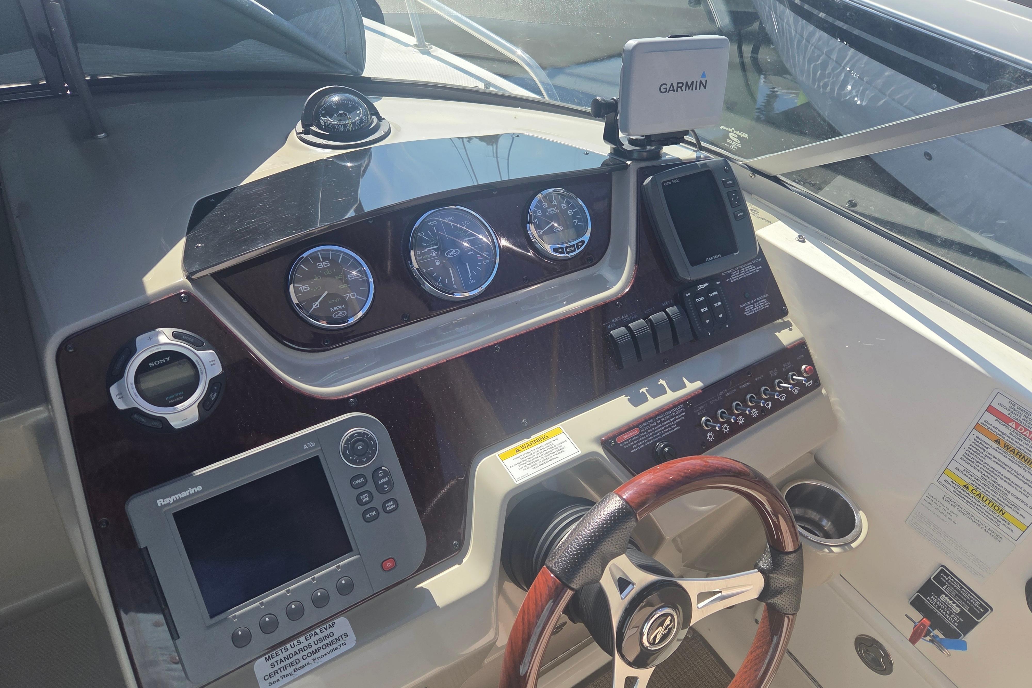 2012 Sea Ray Sundancer 260 dashboard with Garmin and Raymarine navigation systems.