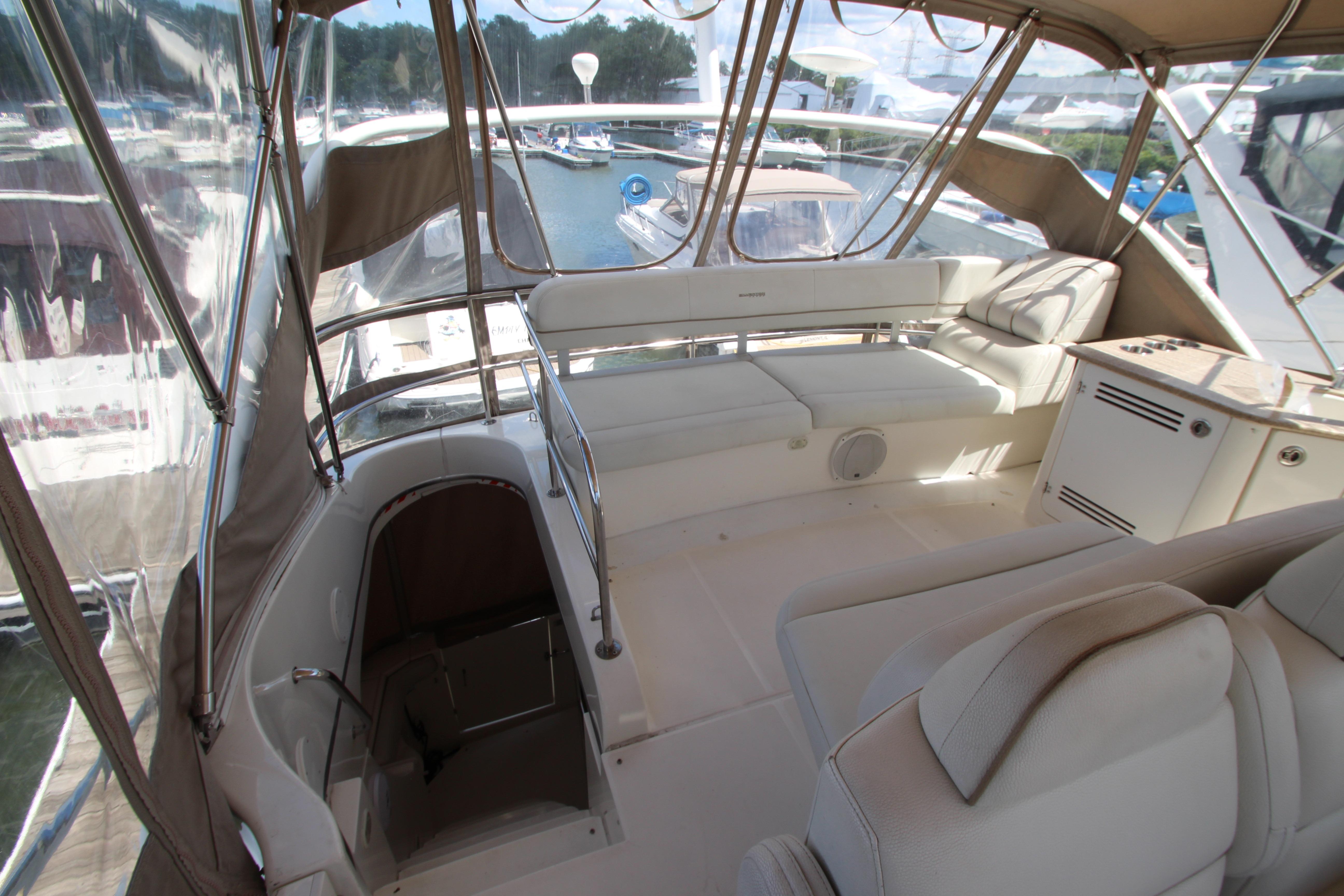 2006 Silverton 38 Sport Bridge interior with seating and helm, docked at marina.