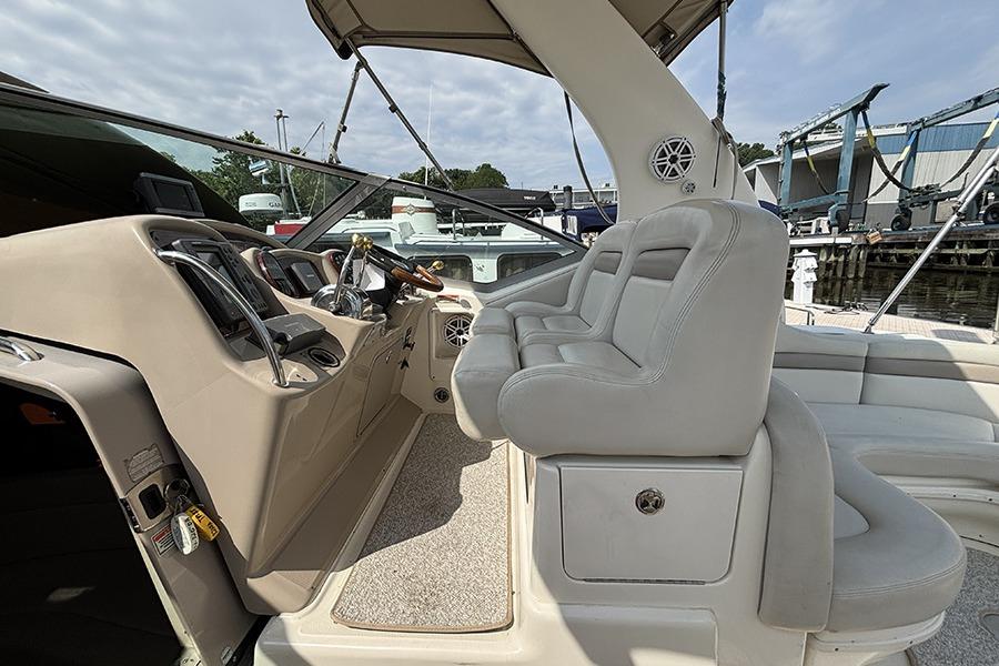 2002 Sea Ray Sundancer 320 cockpit with plush seating and modern controls.