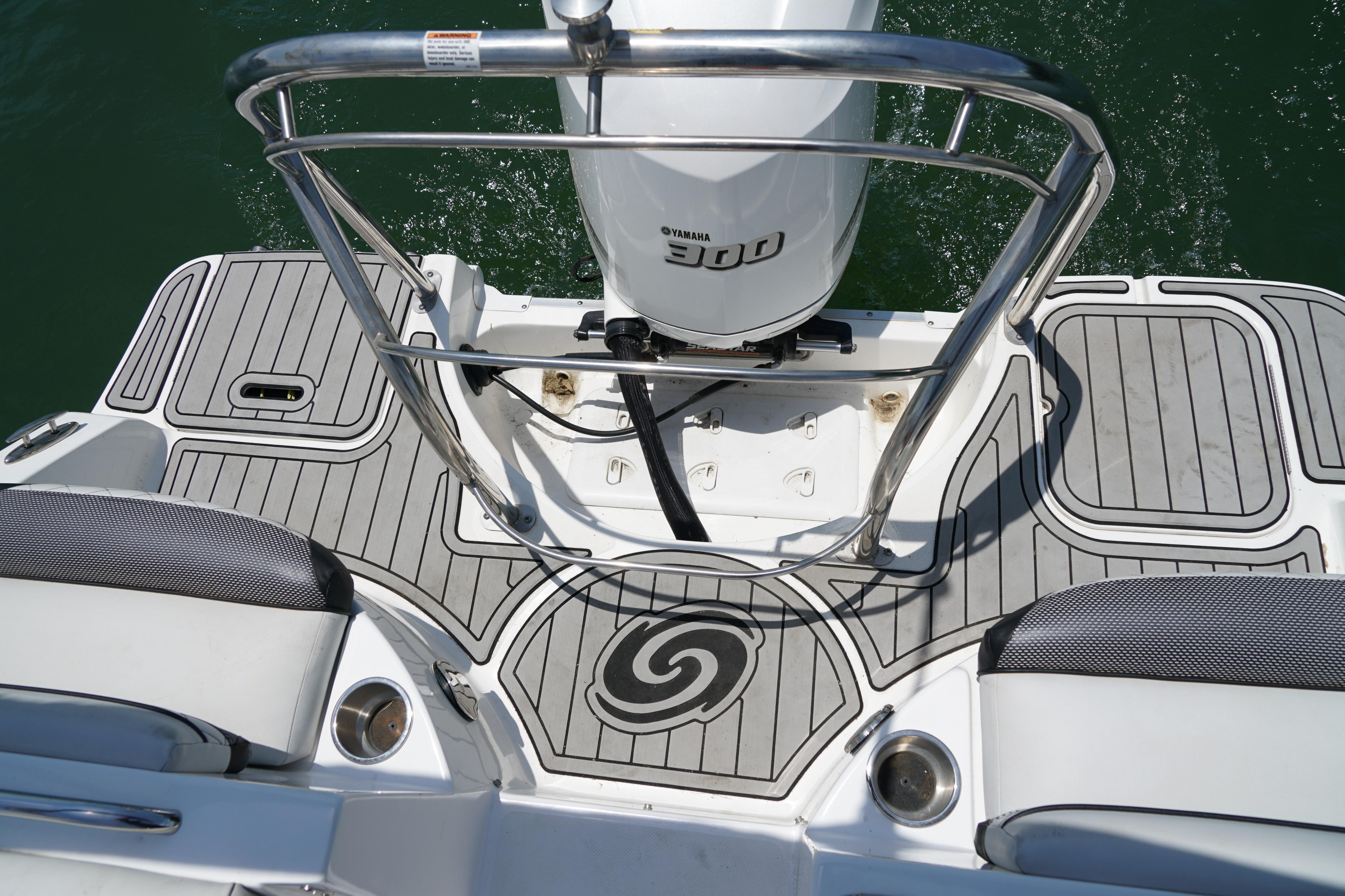 2020 Hurricane SunDeck 2486 OB boat deck with Yamaha engine, gray non-slip flooring.