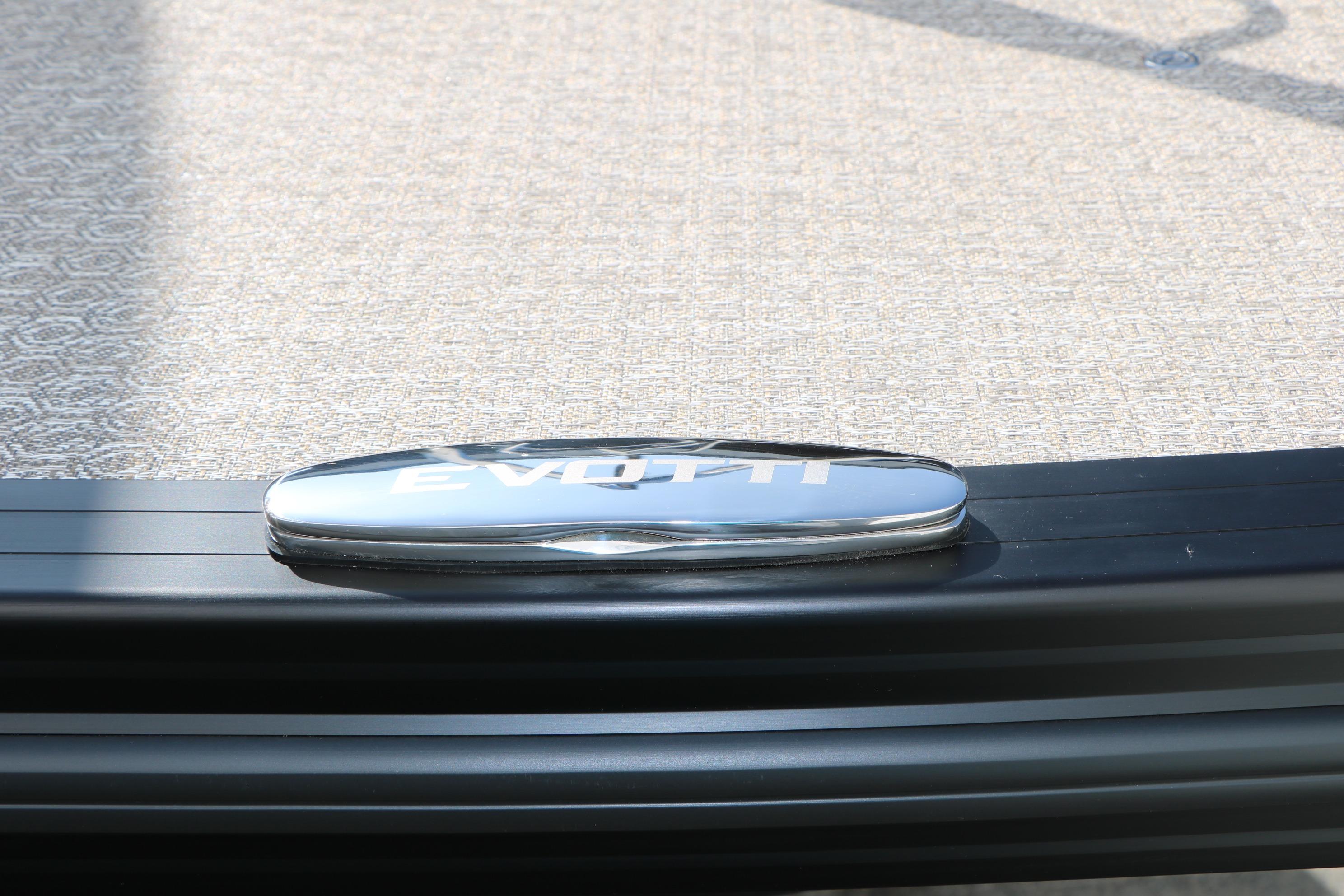 2026 Evotti 723CS logo on sleek black trim, textured background.
