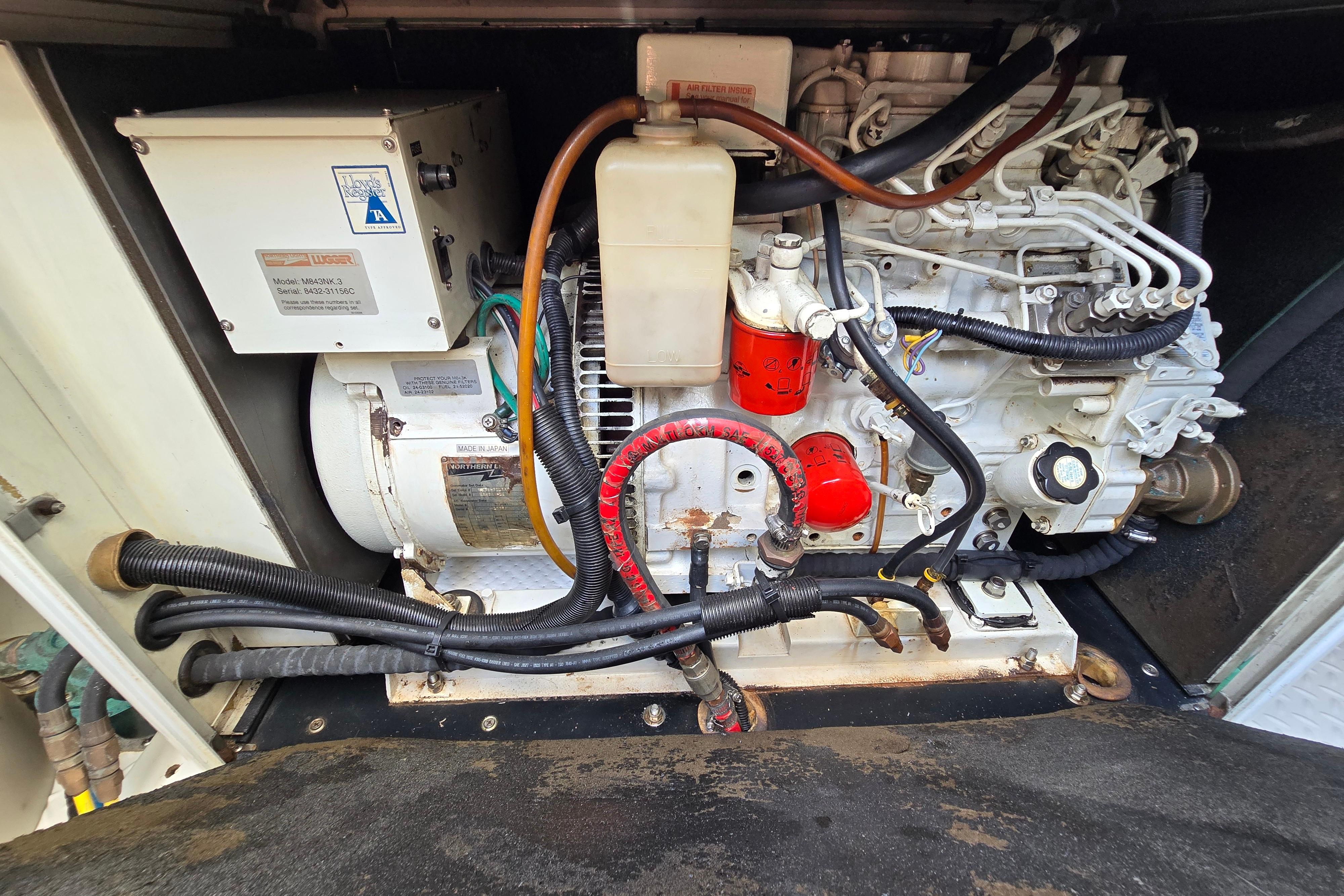 Engine compartment of a 2004 Grand Harbour 58 yacht, showcasing mechanical components and wiring.